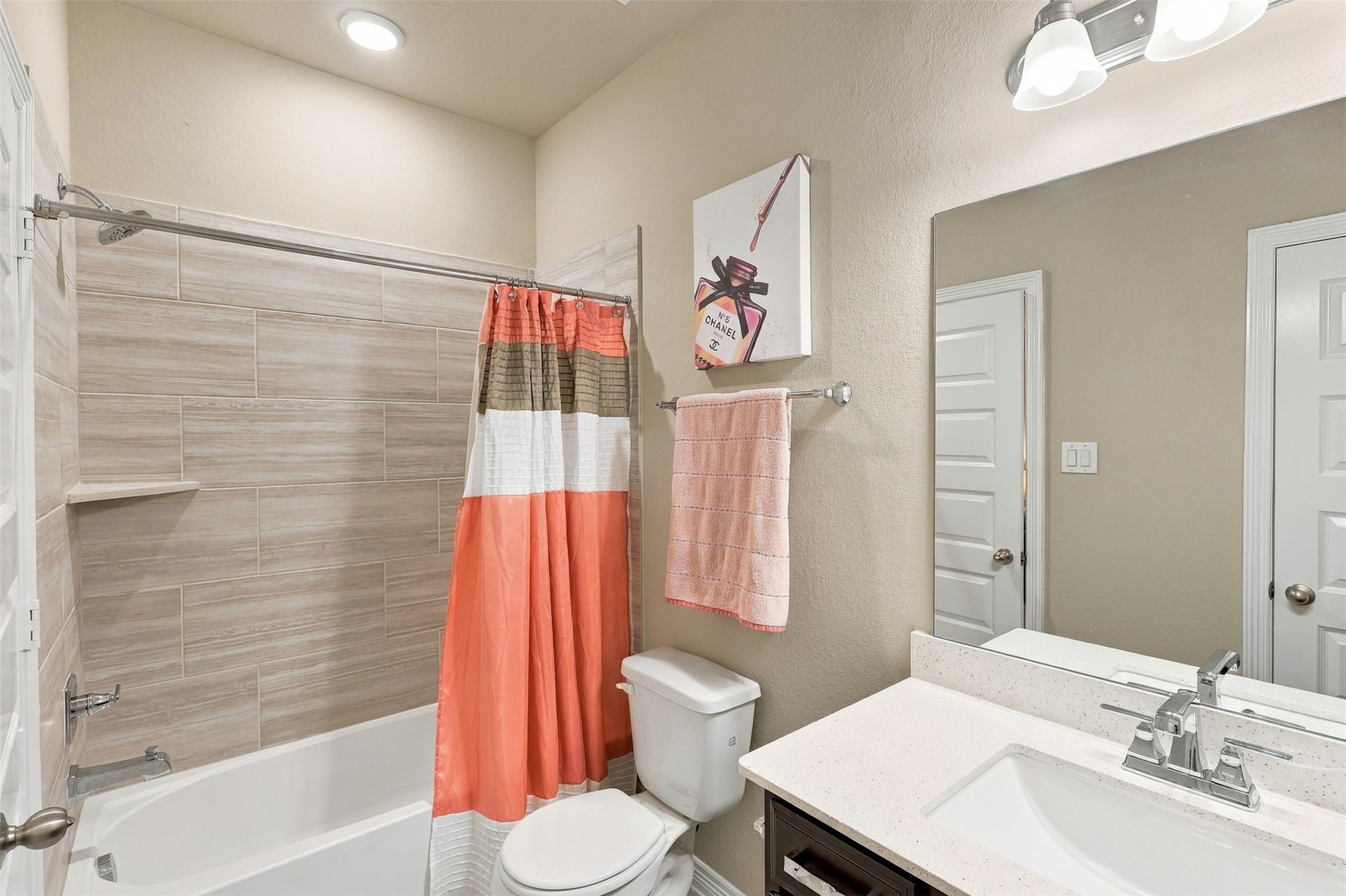 A PRIVATE BATHROOM JUST FOR YOUR GUESTS! This BEAUTIFUL guest suite features its very own luxurious full bathroom, offering wonderful privacy and comfort! Gorgeous gleaming QUARTZ countertops, a deep undermount sink, and stunning designer tile surrounding the tub and shower combination create an elegant, spa-inspired atmosphere! And WAIT... there's MORE! A convenient LINEN PANTRY provides fantastic additional storage for towels and everyday essentials!