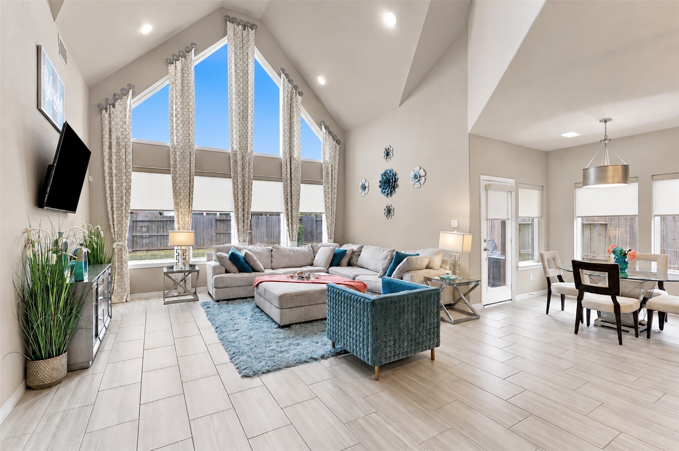 THE WOW FACTOR! Prepare to be AMAZED! Oh, what a breathtaking place to call HOME! This SPECTACULAR family room is a true showstopper, featuring dramatic two-story soaring ceilings, magnificent floor-to-ceiling walls of windows, and elegant designer window treatments! An abundance of natural light pours into this stunning space, creating an atmosphere of warmth, beauty, and sophistication! The incredible open-concept design flows effortlessly into the casual dining area and gourmet kitchen!