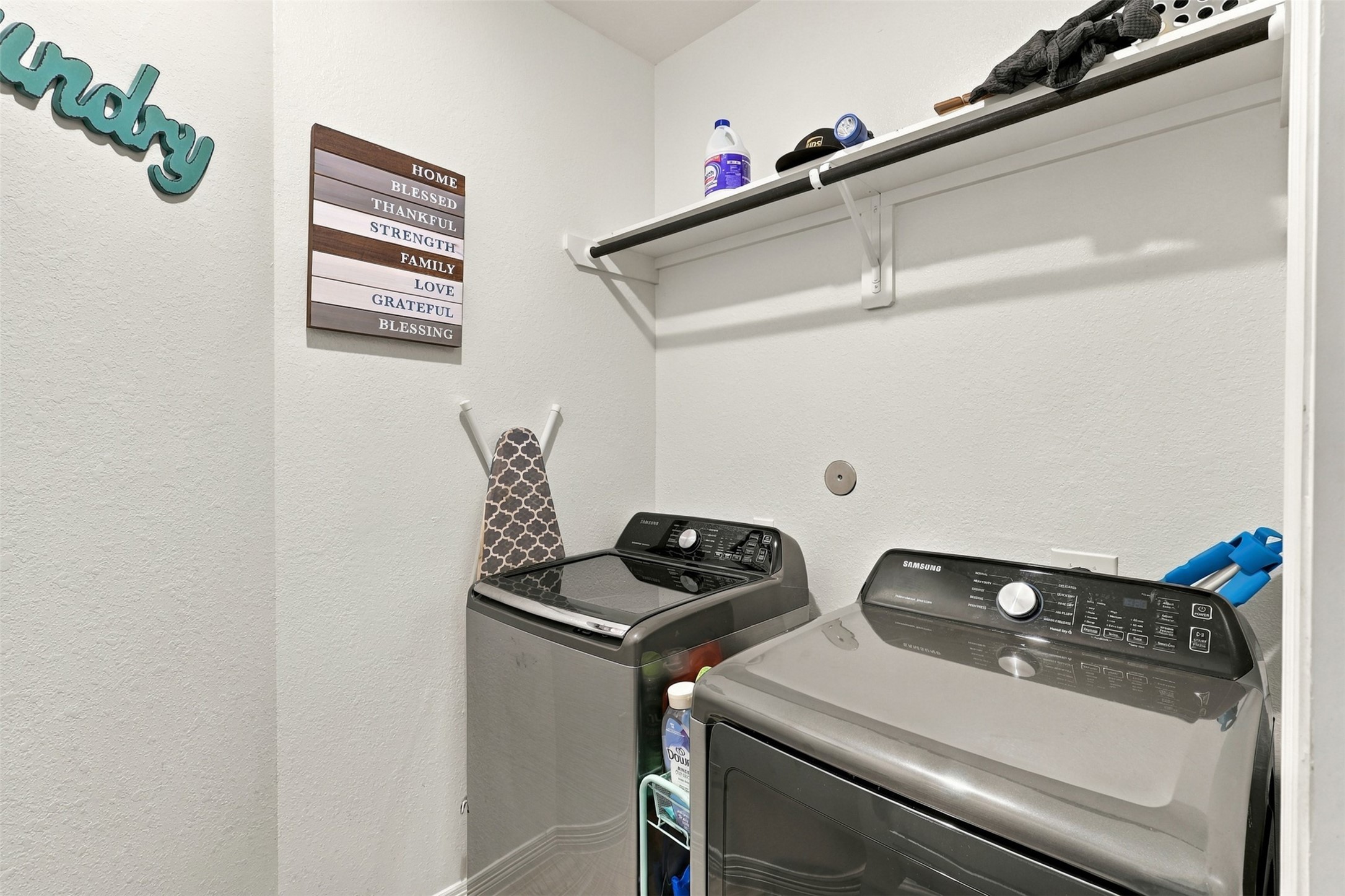 Laundry day just got a little easier! This dedicated utility room features a washer and dryer, convenient shelving, and additional space for laundry essentials. Everything has its place in this practical area designed to keep household routines organized.