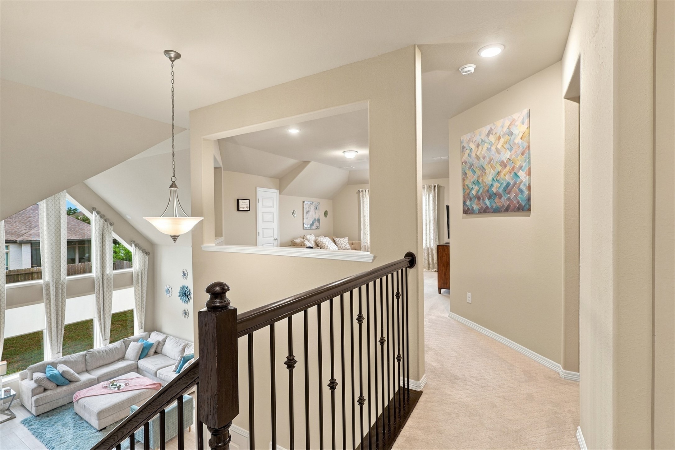 WOW! WHAT A SPECTACULAR VIEW FROM ABOVE! The breathtaking architectural beauty continues upstairs, where elegant open railings overlook the magnificent two-story family room below! Stunning recessed lighting, beautiful neutral finishes, and an impressive open design create an atmosphere of timeless elegance! Follow the upstairs walkway to the PRIVATE LEFT WING, where you'll discover a fabulous GAME ROOM perfect for entertaining and an incredible GUEST SUITE with its own PRIVATE FULL BATHROOM!