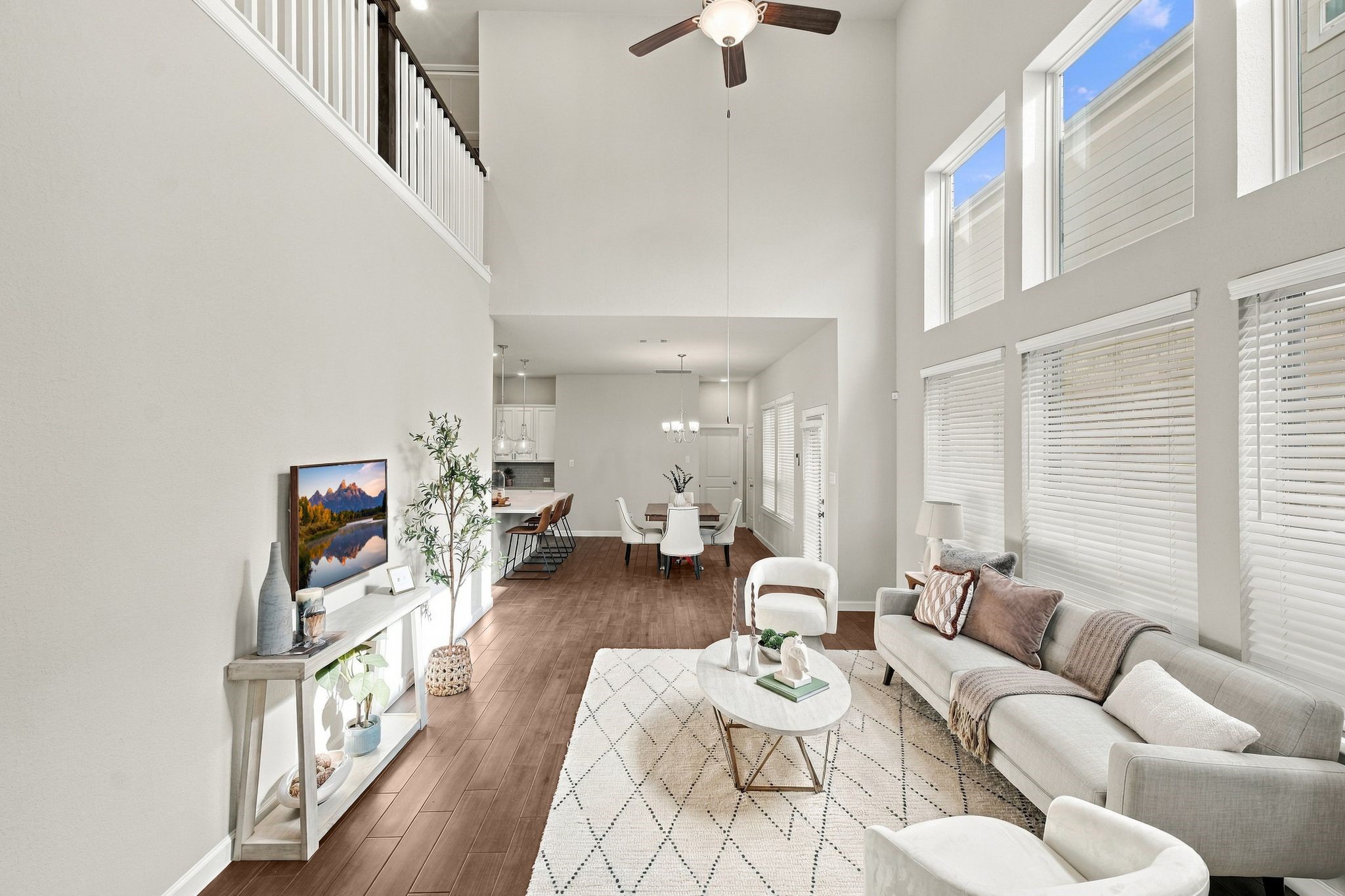A two story wall of windows and an open loft above. Light, elevated, unmistakable.