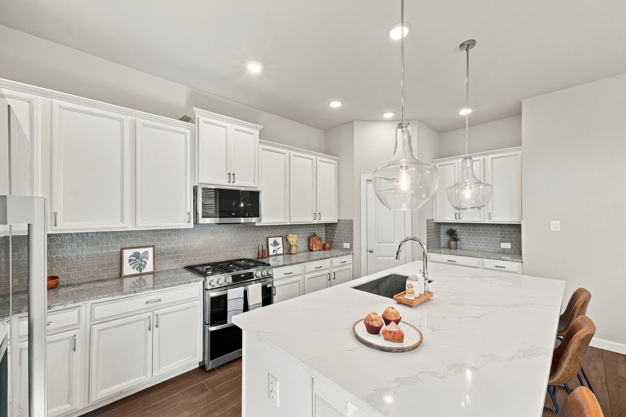 This is the one. The kitchen everyone will fight over. A brand new quartz island, white stained cabinetry, and enough counter space for a real cook, not just a photo. This is the one. The kitchen everyone will fight over. A brand new quartz island, white stained cabinetry, and enough counter space for a real cook, not just a photo.