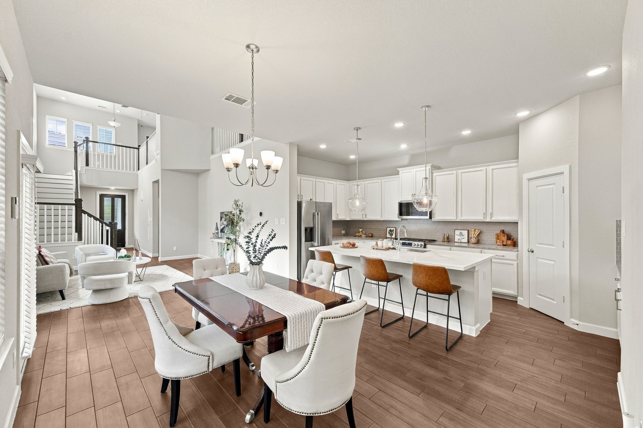 One open space, endless ways to live in it. Kitchen, dining, and family room flow together without a single wall breaking up the conversation.