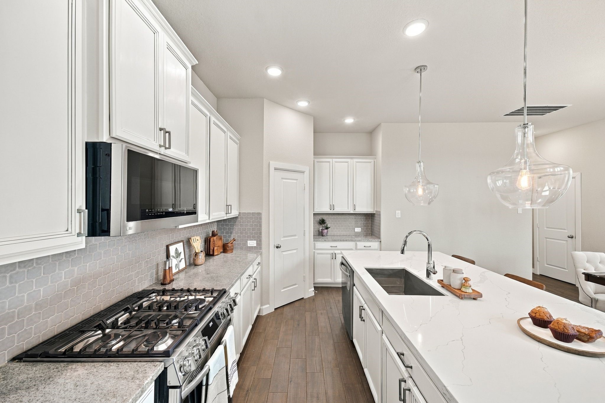 A gas range, pendant lighting, and a walk in pantry just steps away. Everything a home chef actually uses.