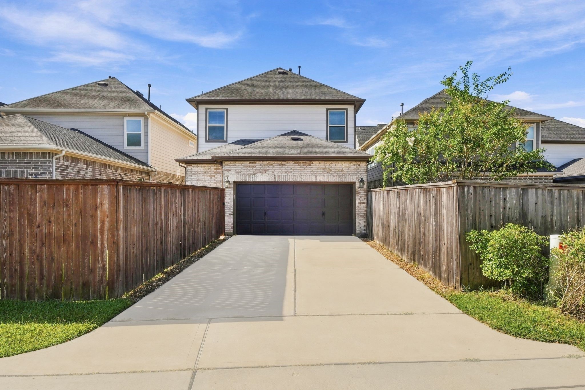 Two car garage, clean driveway, a first impression that holds up.