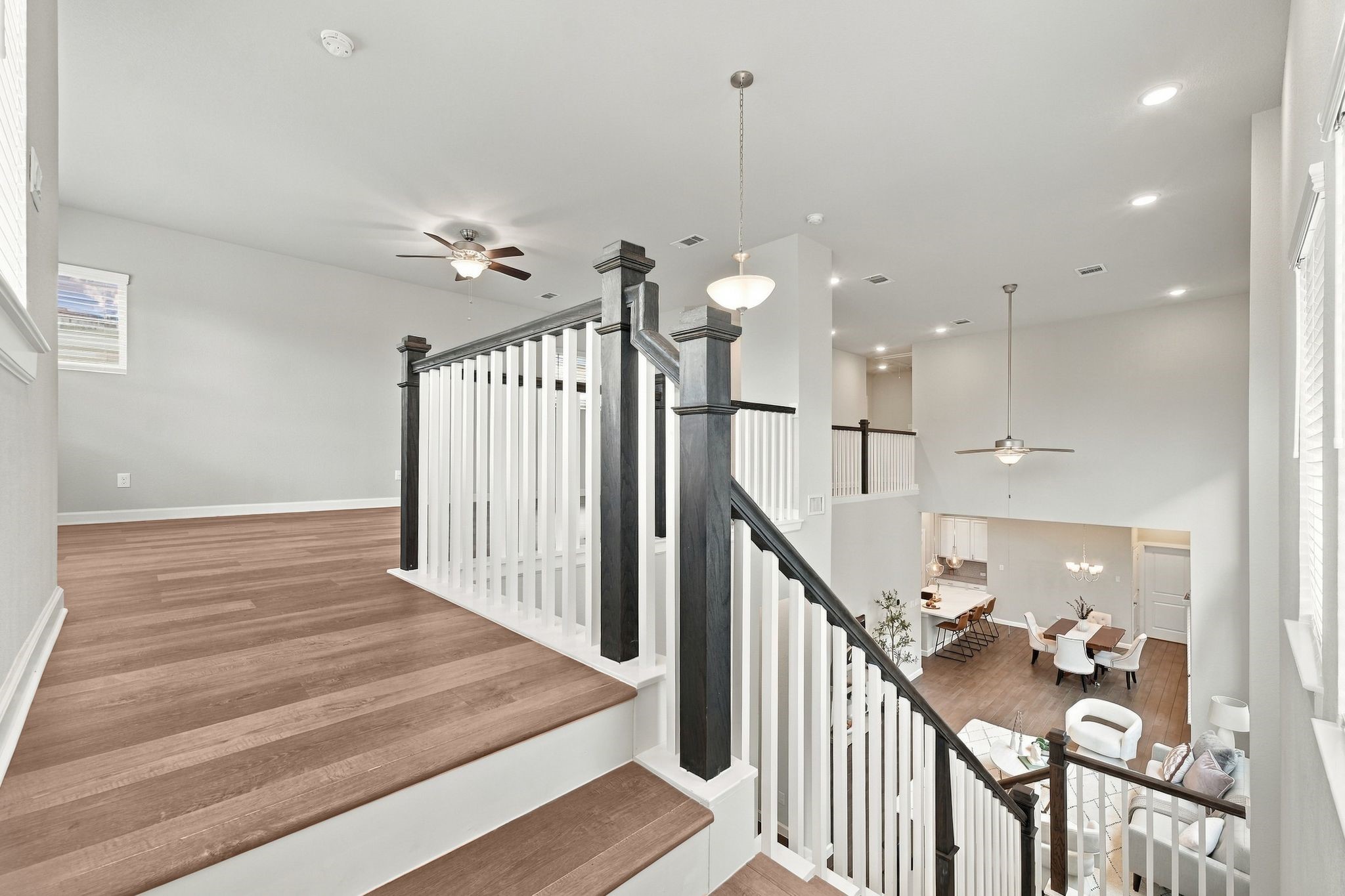 The loft overlooks it all, staircase, entry, and the great room below.