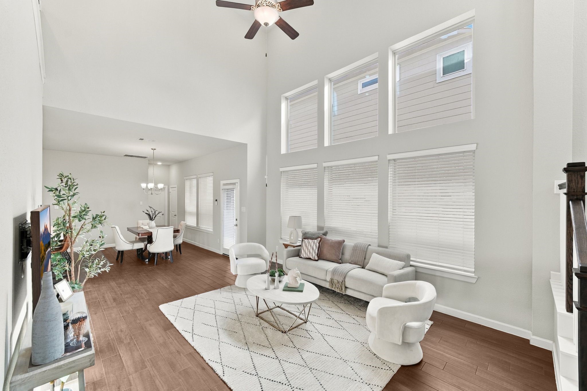 Ceilings that make a statement before a single piece of furniture does. Two full stories of windows flood this room with light.