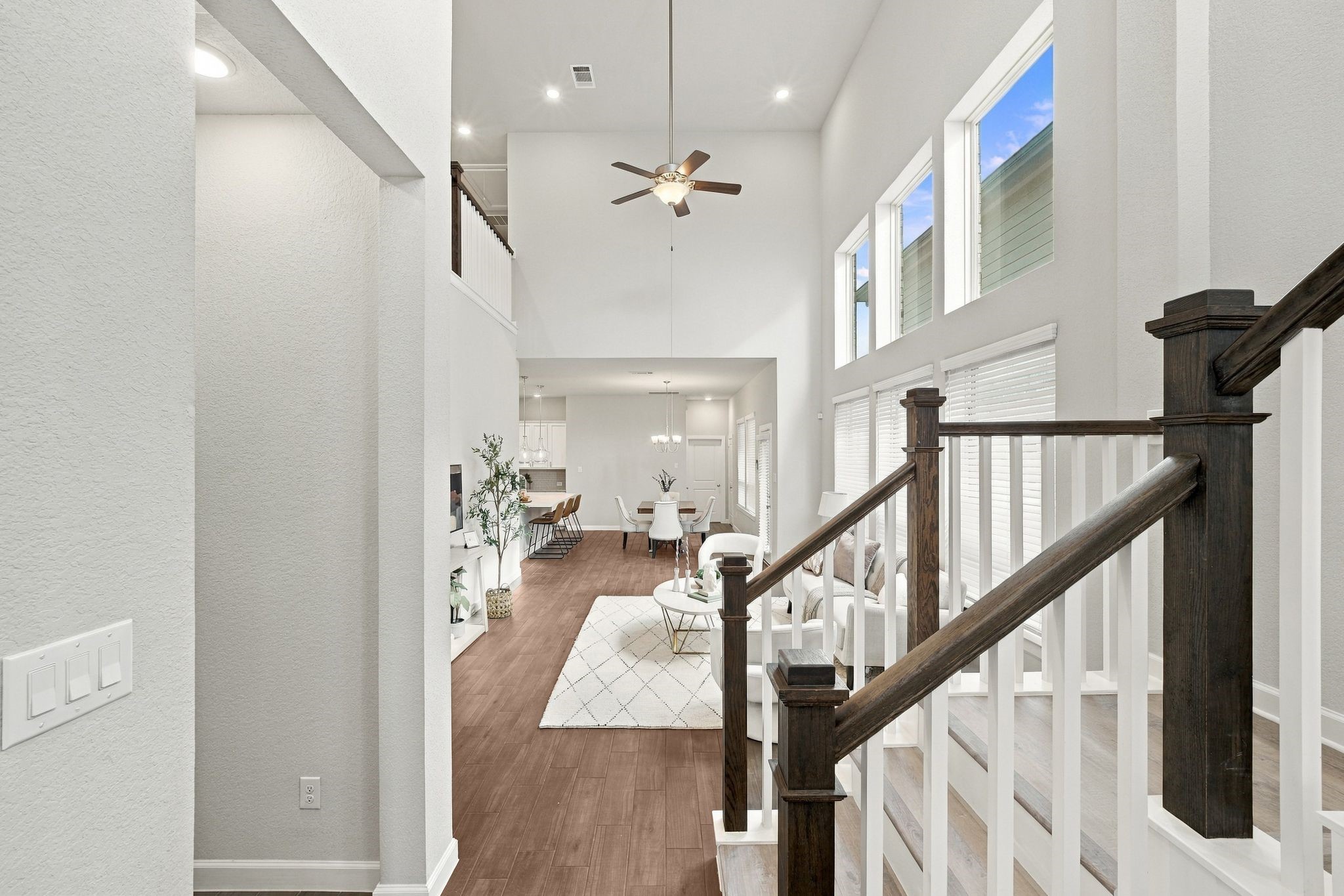 One clean sightline from entry to living to dining. This is how families actually live.