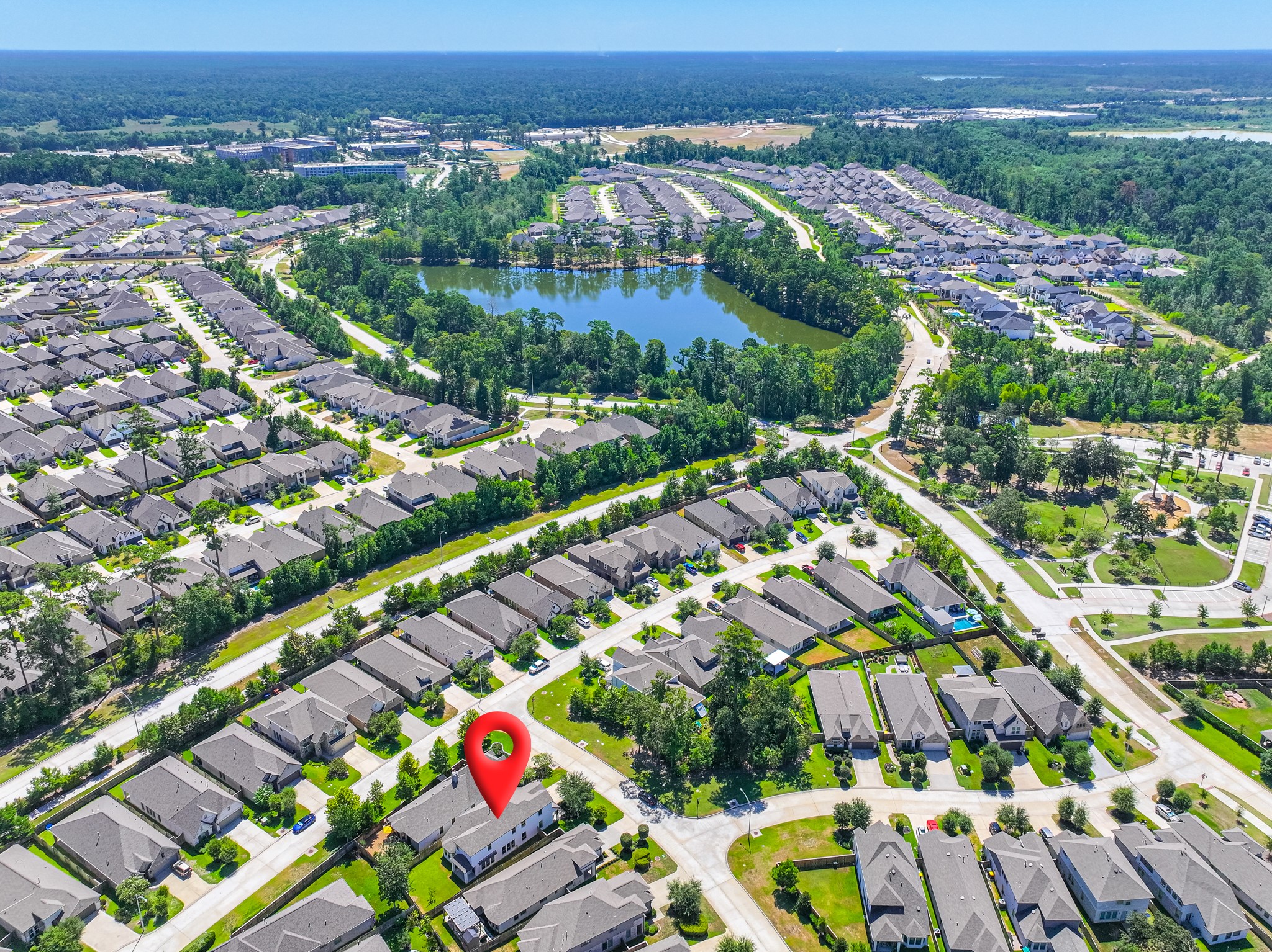 Overhead community aerial showcasing Grand Central Park's beautifully planned layout  tree-lined streets, the expansive 88-acre Grand Lake, neighborhood parks, and exceptional recreational amenities spread throughout this extraordinary Conroe, TX community.