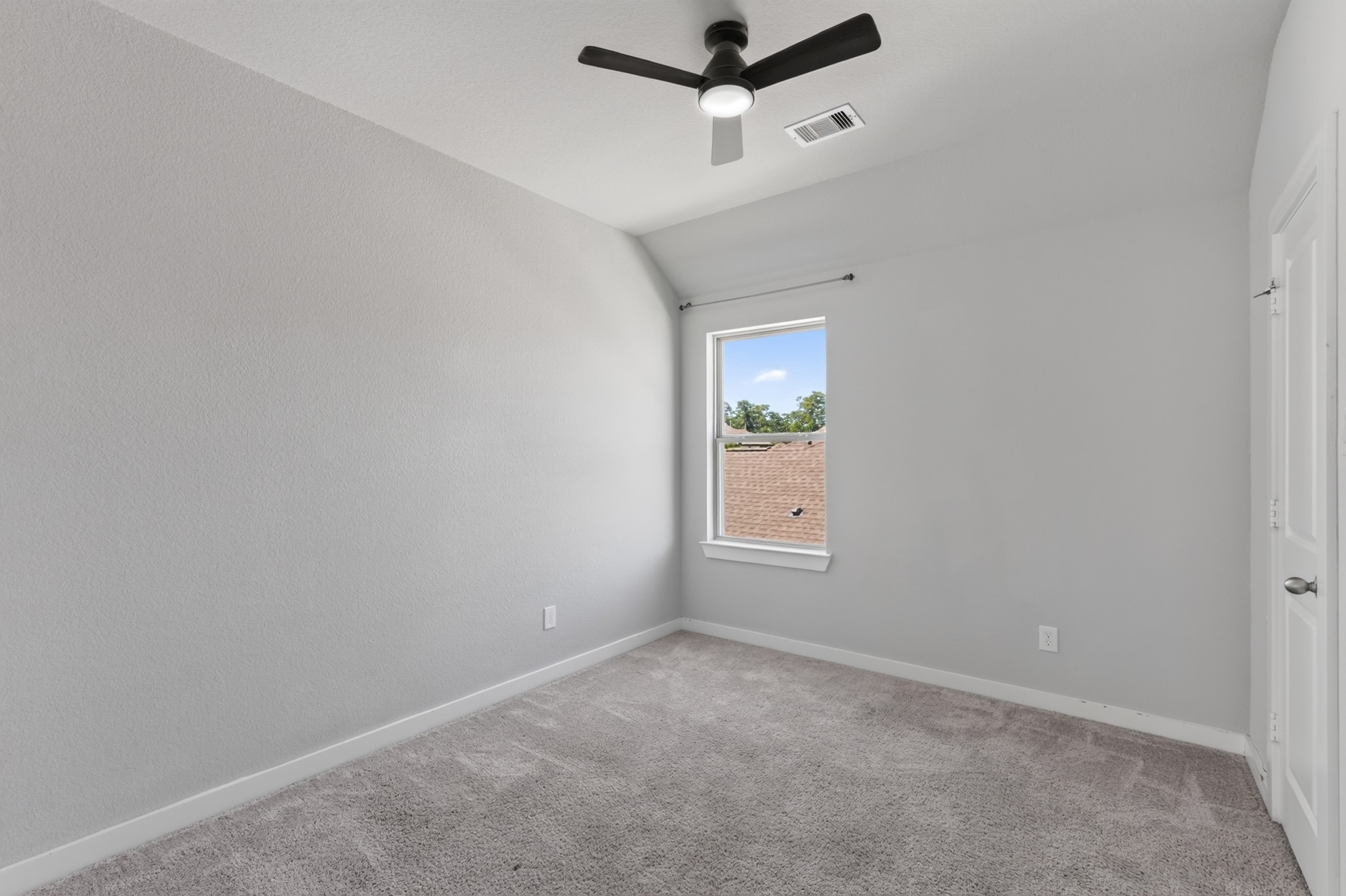Third secondary bedroom with a ceiling fan, soft carpet flooring, and a window for natural light. Neutral tones make decorating easy, giving future occupants the freedom to personalize this bright, comfortable room exactly the way they want it.