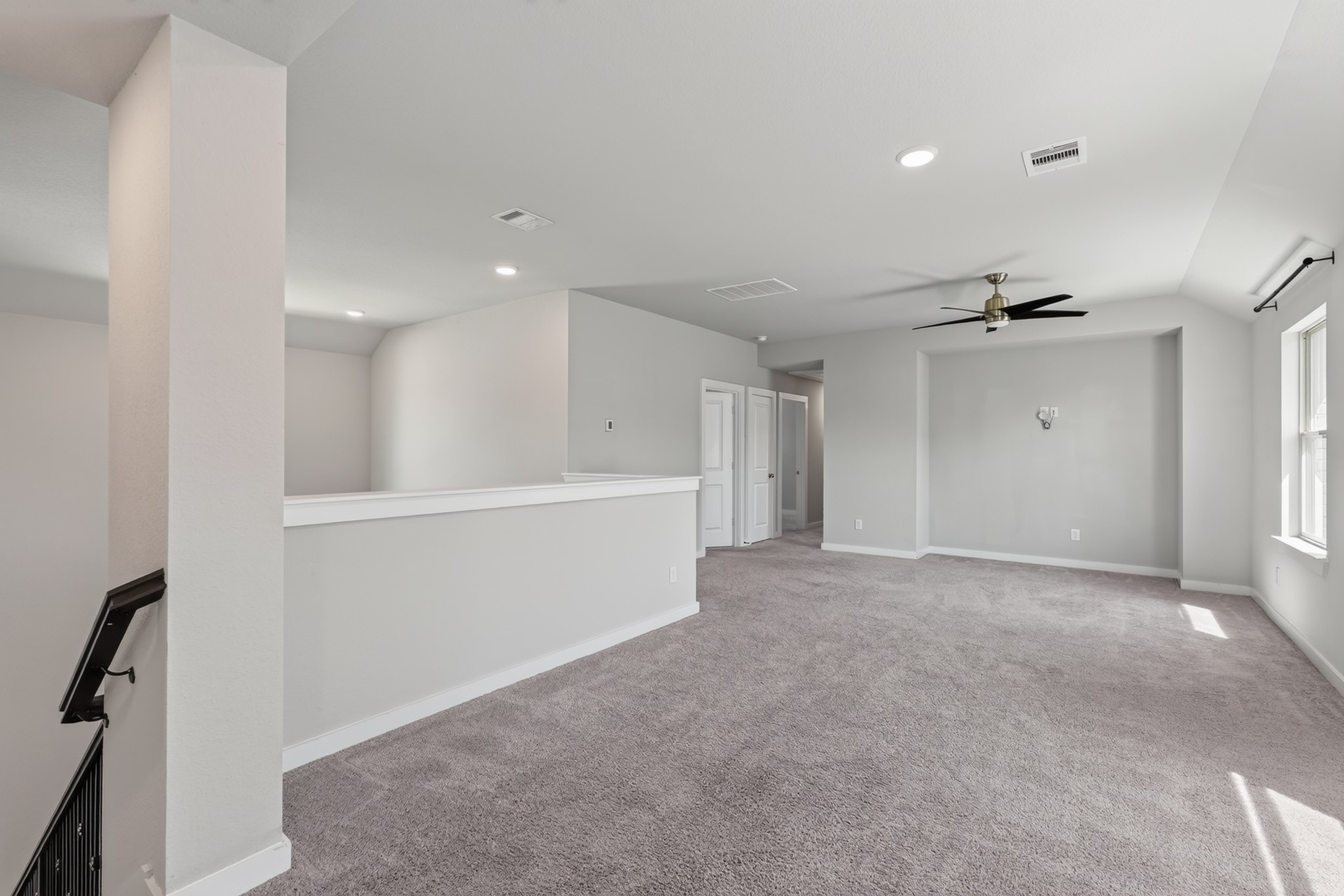 The upstairs game room is a spectacular bonus space  large, open, and flexible with plush carpet, a ceiling fan, and bright neutral walls. Use it as a playroom, media room, home gym, or second family living area for the whole household to truly enjoy.