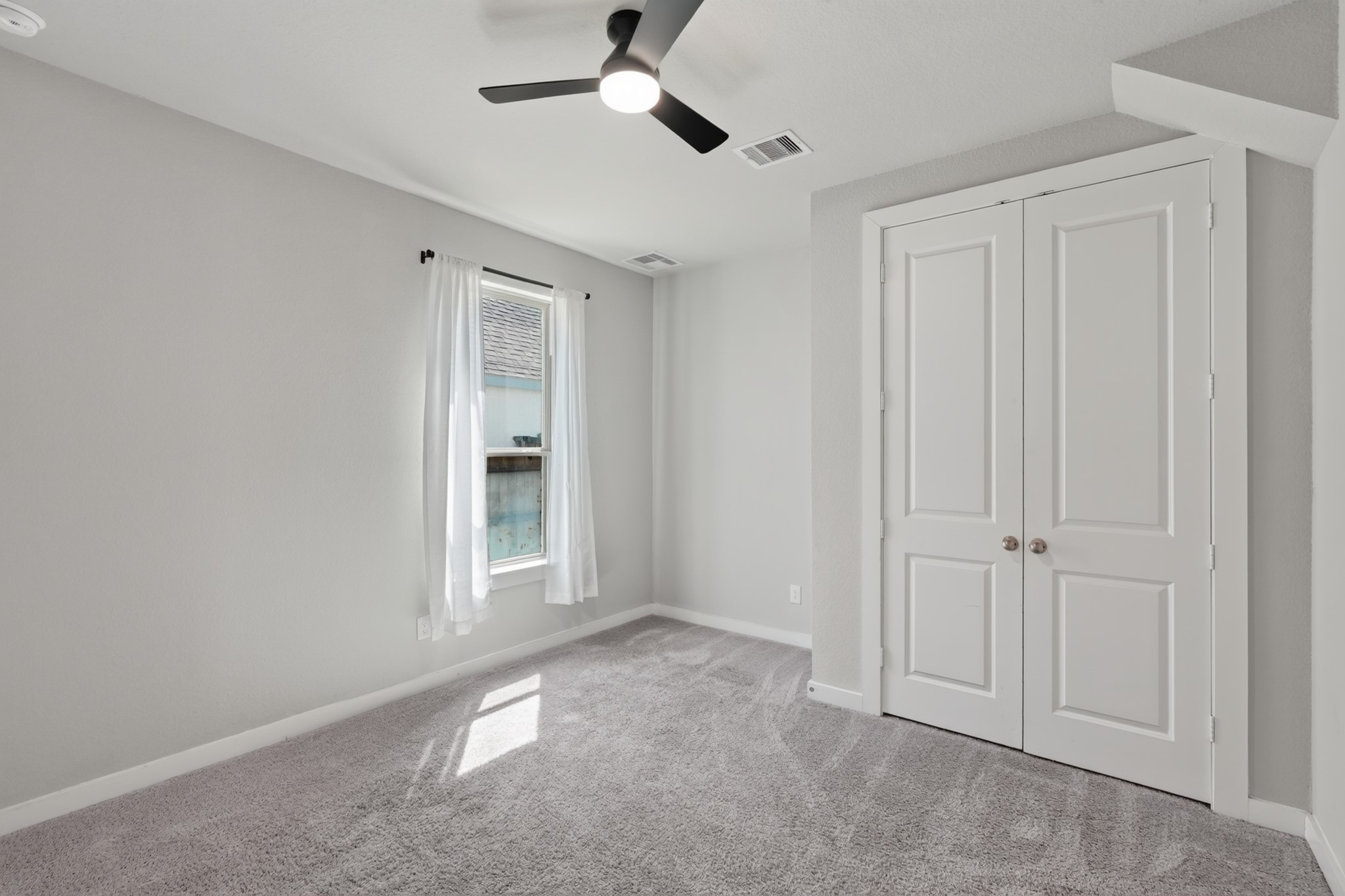 Secondary bedroom featuring plush carpet, a ceiling fan, and a closet  a comfortable, well-lit room ready for family, guests, or a home office. Neutral walls make personalizing this warm and inviting space effortless from the very first day of move-in.