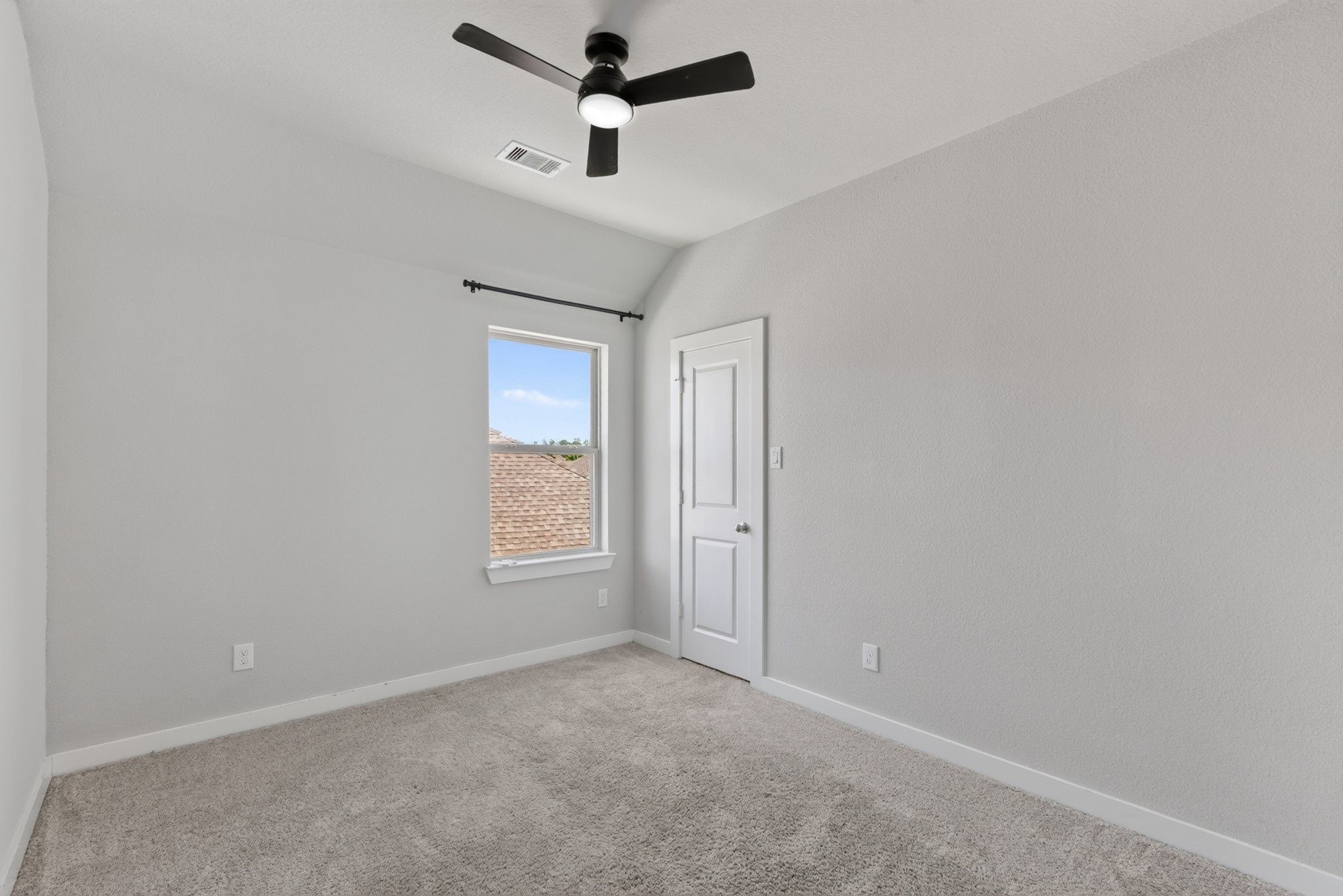 Upper-level secondary bedroom featuring a ceiling fan, soft carpet, and windows for natural light  a comfortable and private retreat for family or guests. Clean, bright, and move-in ready, this room is the perfect space to make your own from day one.