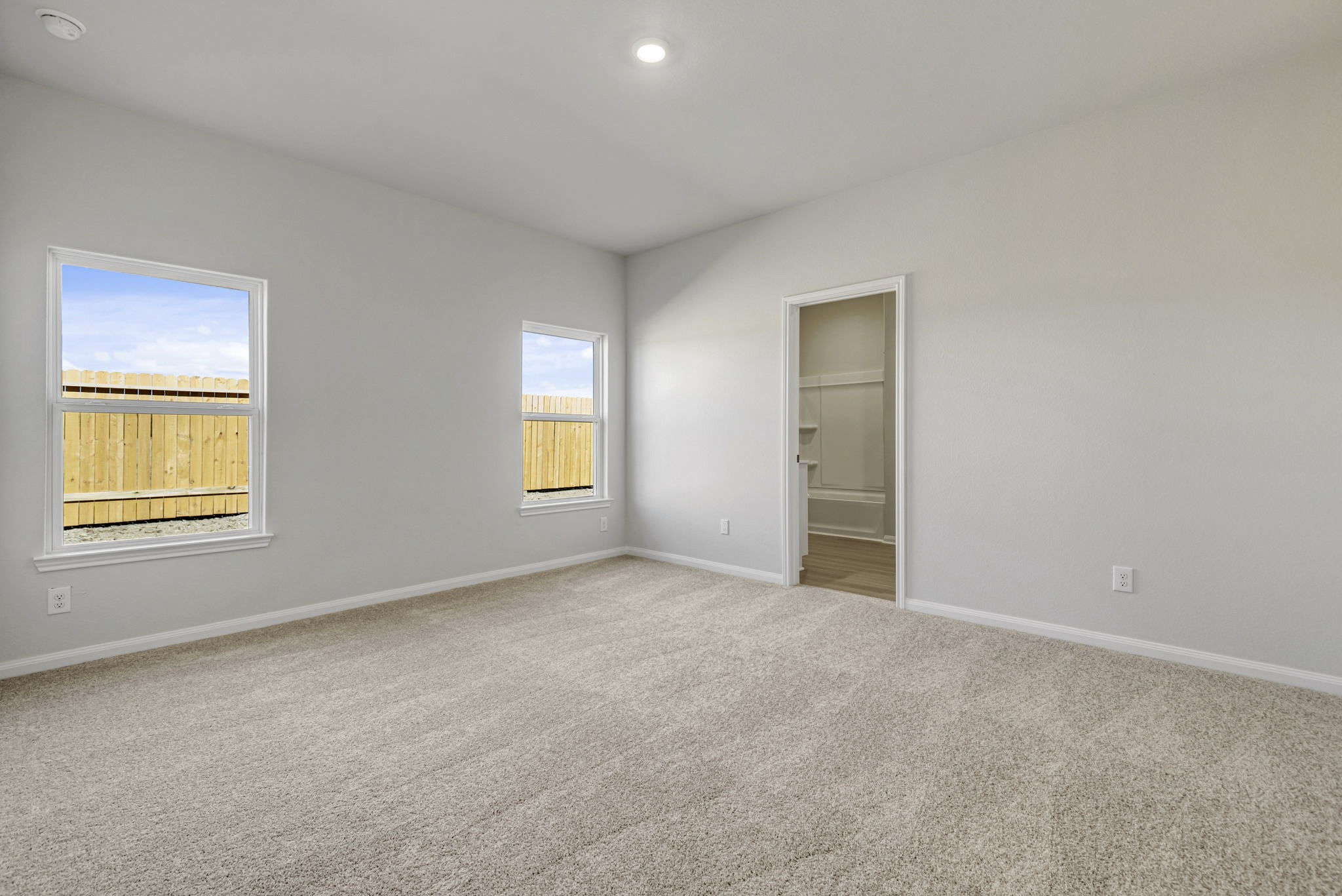 The primary bedroom has beautiful windows that let in plenty of natural light. The primary bedroom has beautiful windows that let in plenty of natural light.