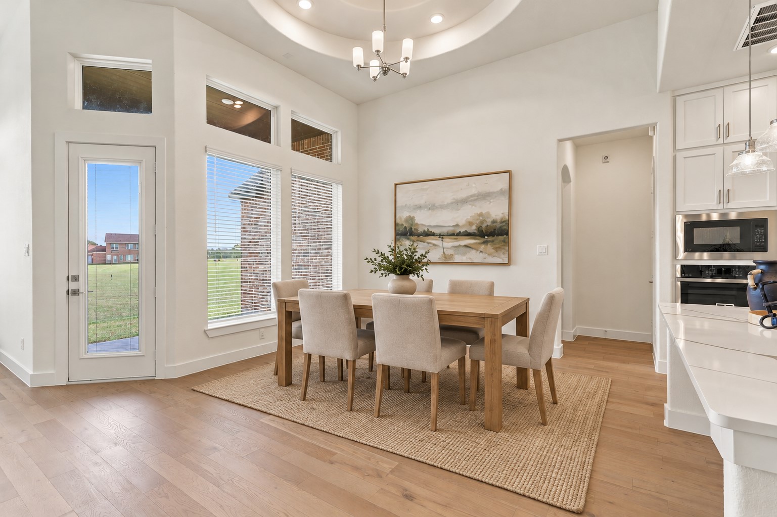 WHAT A BEAUTIFUL PLACE TO GATHER & MAKE MEMORIES! Imagine hosting WONDERFUL FAMILY DINNERS, festive holiday celebrations & unforgettable gatherings in this ELEGANT DINING AREA! A DRAMATIC CEILING DESIGN and STUNNING STATEMENT CHANDELIER create an impressive first impression, while LARGE WINDOWS welcome an abundance of BEAUTIFUL NATURAL LIGHT! GORGEOUS ENGINEERED WOOD FLOORING adds warmth, sophistication & timeless charm! Virtual Stage!