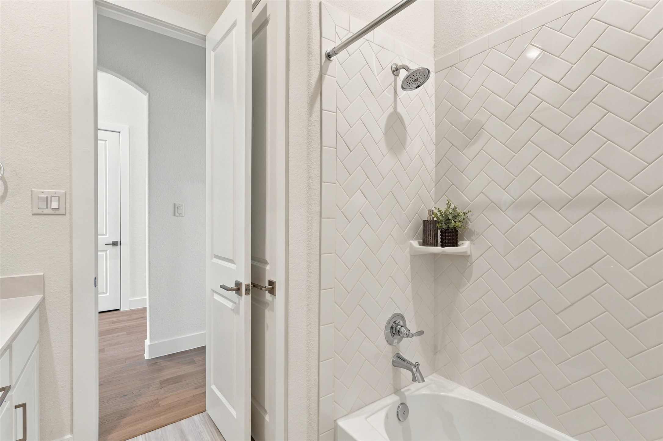 FRESH, BRIGHT & BEAUTIFULLY DESIGNED! Prepare to APPRECIATE the thoughtful details in this inviting secondary bathroom! Gorgeous light-colored tile surrounds the tub and shower combination, while the stylish built-in shower niche adds convenient storage for your essentials! A BEAUTIFUL blend of style and functionality!