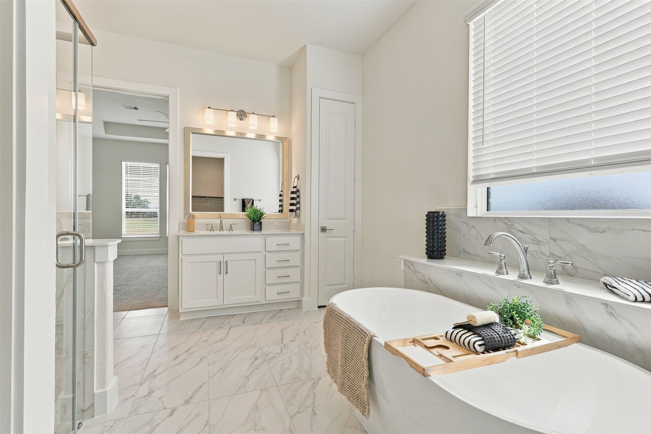 RELAXATION STARTS HERE! Imagine soaking your cares away in this BEAUTIFUL DEEP SOAKING TUB, perfectly positioned beneath a FROSTED GLASS WINDOW welcoming soft natural light while maintaining privacy! GORGEOUS TILE FLOORING, a SPACIOUS PRIVATE VANITY with SPARKLING QUARTZ COUNTERTOPS, DEEP UNDERMOUNT SINK & an ABUNDANCE OF CABINETS & DRAWERS! AND THERE'S MORE! Enjoy a CONVENIENT LINEN PANTRY for even more storage! YOUR OWN SPA-INSPIRED ESCAPE awaits!