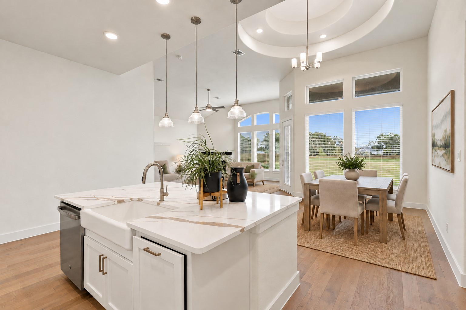 GORGEOUS KITCHEN & DINING IN PERFECT HARMONY! Prepare to be IMPRESSED by this spacious center island featuring gleaming QUARTZ countertops, crisp white cabinetry, and elegant pendant lighting! The adjoining dining area and open layout create a seamless connection between cooking, dining, and entertaining! BRIGHT, AIRY & BEAUTIFULLY DESIGNED, this is a place where wonderful memories begin! **Photo is Virtually Staged**
