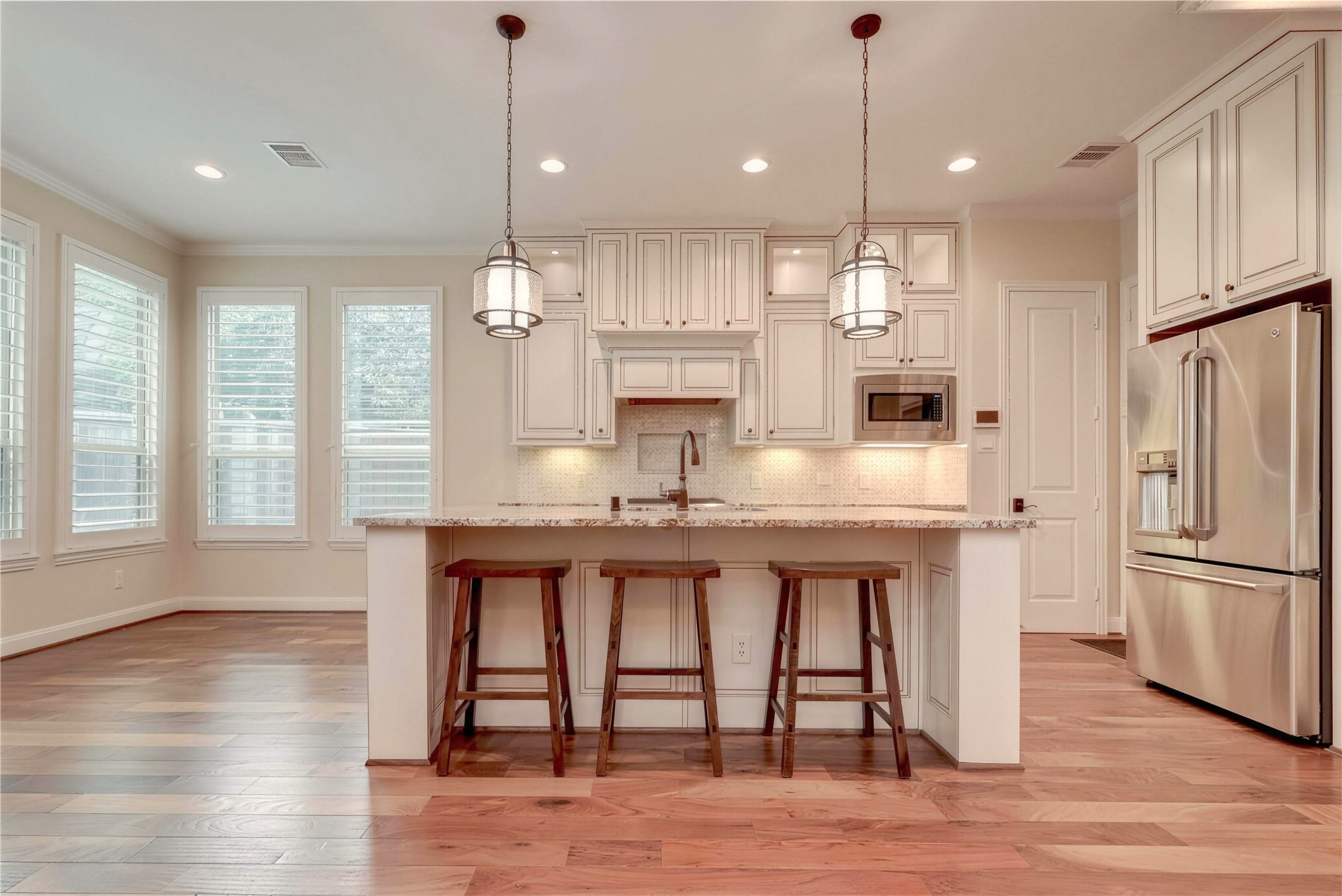 Bright and spacious kitchen with elegant cabinetry, granite countertops, and a large island perfect for entertaining.
