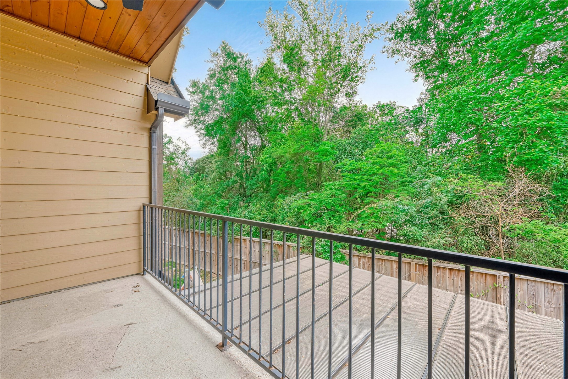 Enjoy serene views of lush greenery from this spacious balcony, perfect for relaxation and outdoor enjoyment.