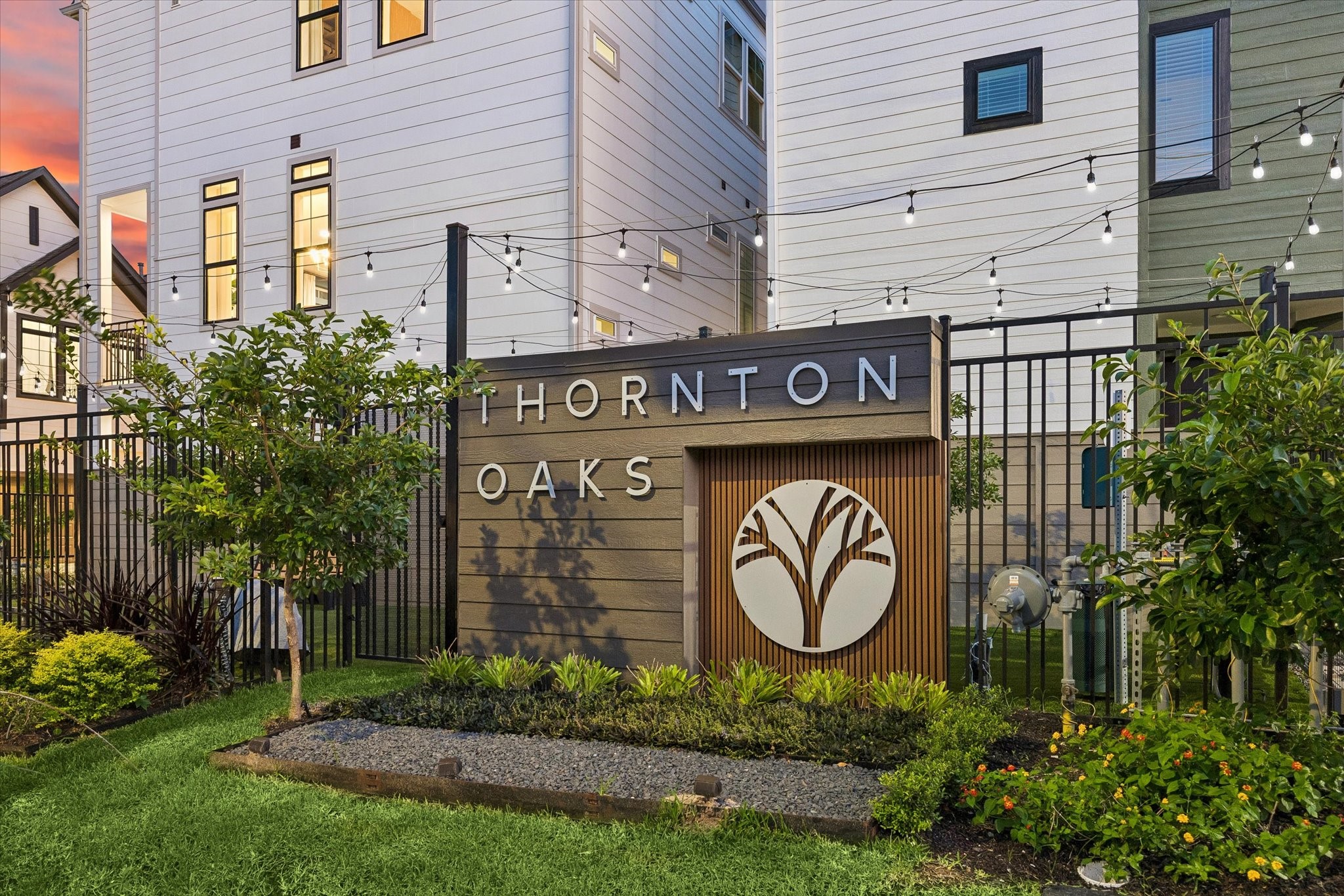 Thornton Oaks entry monument with lush landscaping and boutique identity