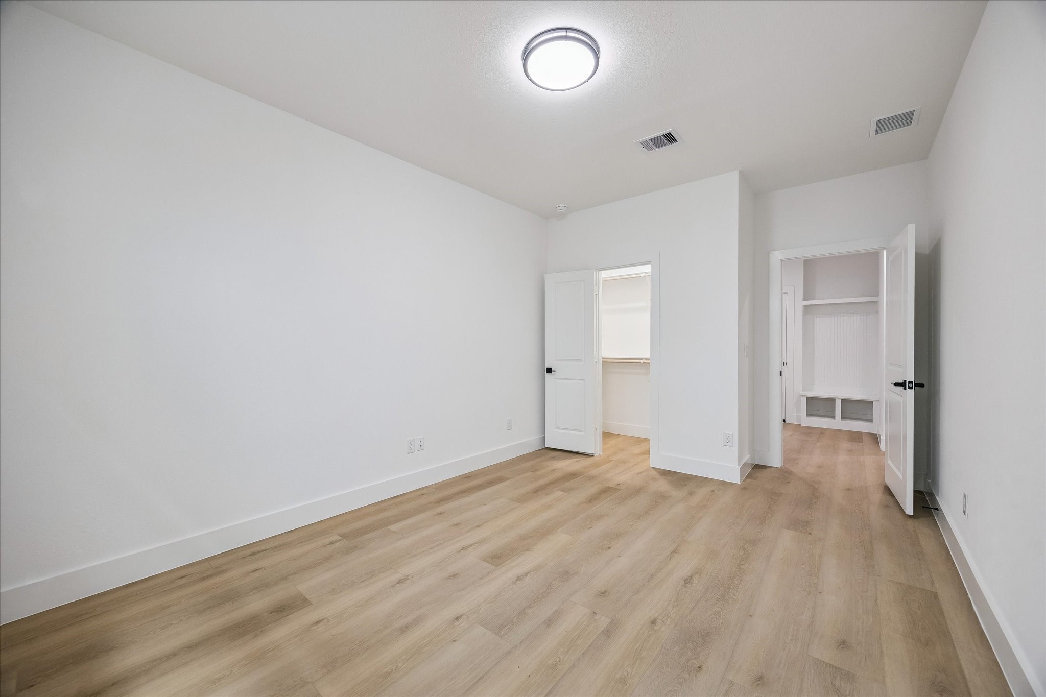 Secondary bedroom with simple, comfortable proportions and neutral palette