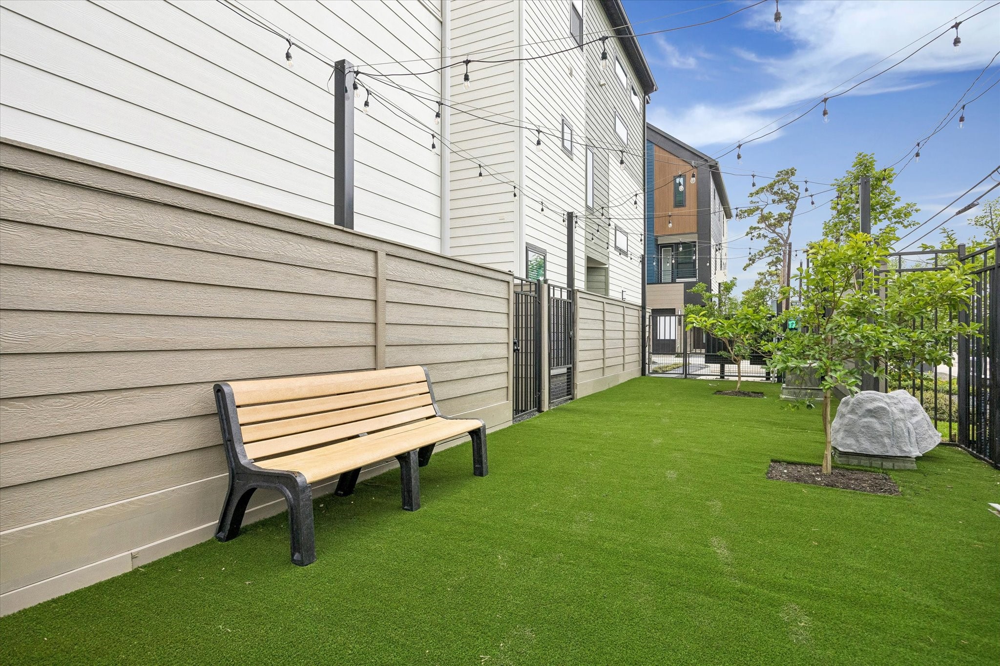 Dogs Park with turf yard & seating area, privacy fencing, and inviting outdoor use