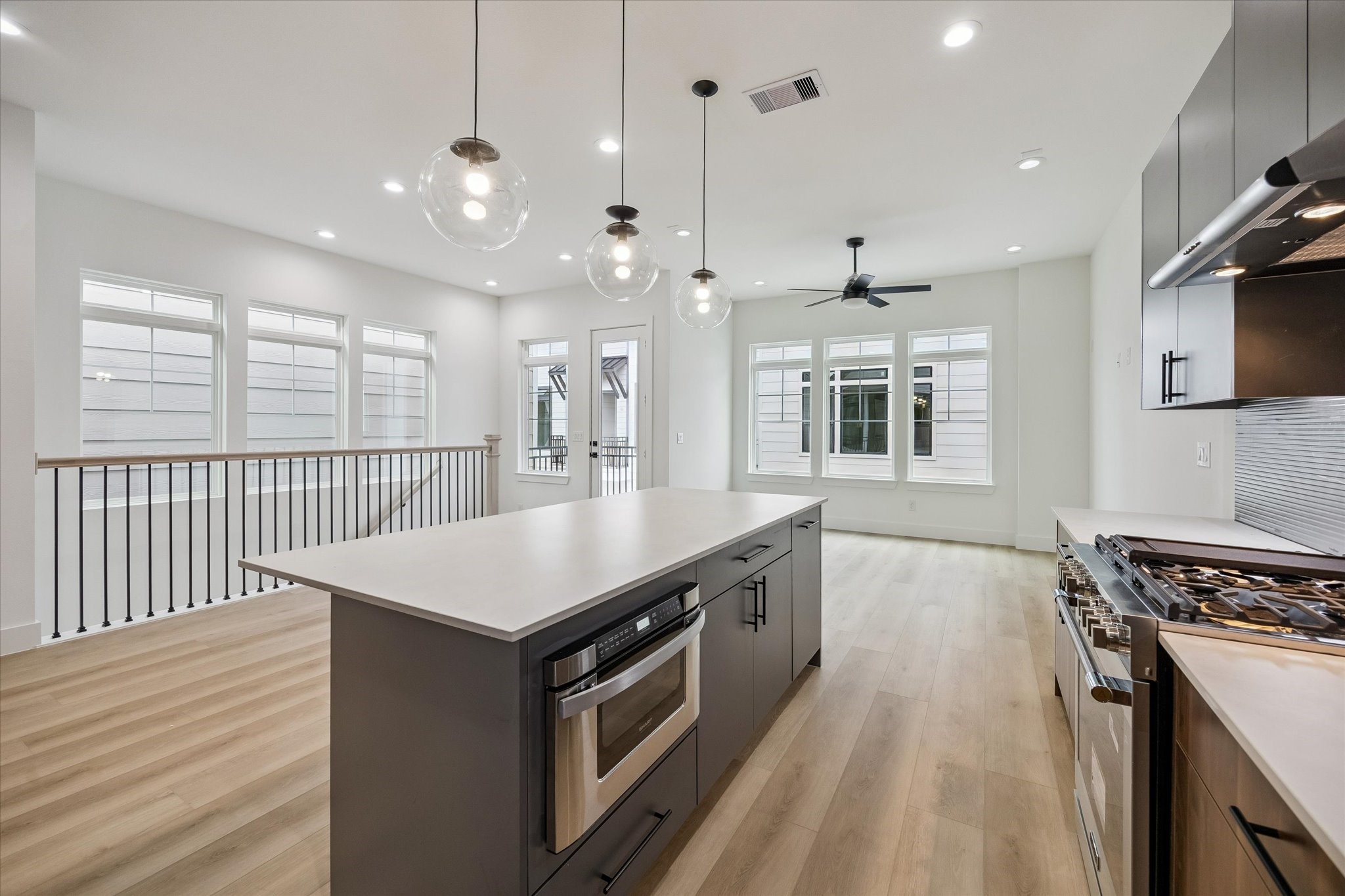 Kitchen-centered layout with oversized island and clear sightlines Kitchen-centered layout with oversized island and clear sightlines