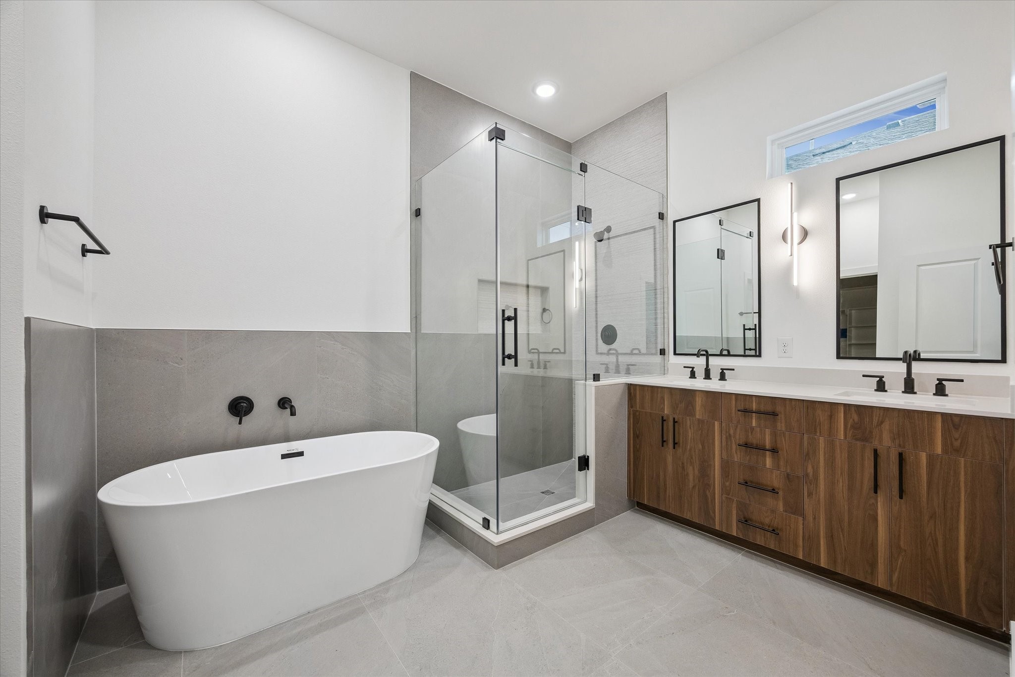 Primary bath with freestanding tub, glass shower, and spa-like feel