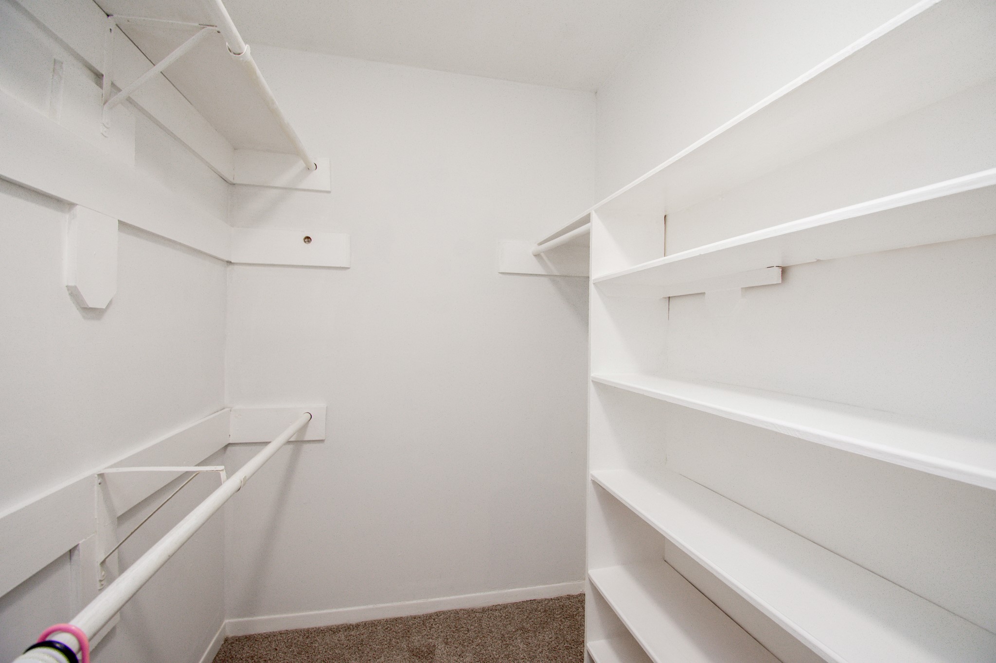 Primary bedroom walk-in Closet one accessed from the bedroom
