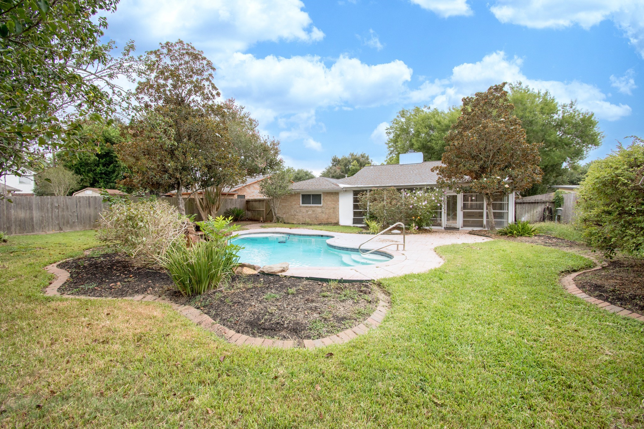 Move-in ready. This backyard not only has a pool, a shed, extensive decking, sprinklers but there's still a lot of yard left over!