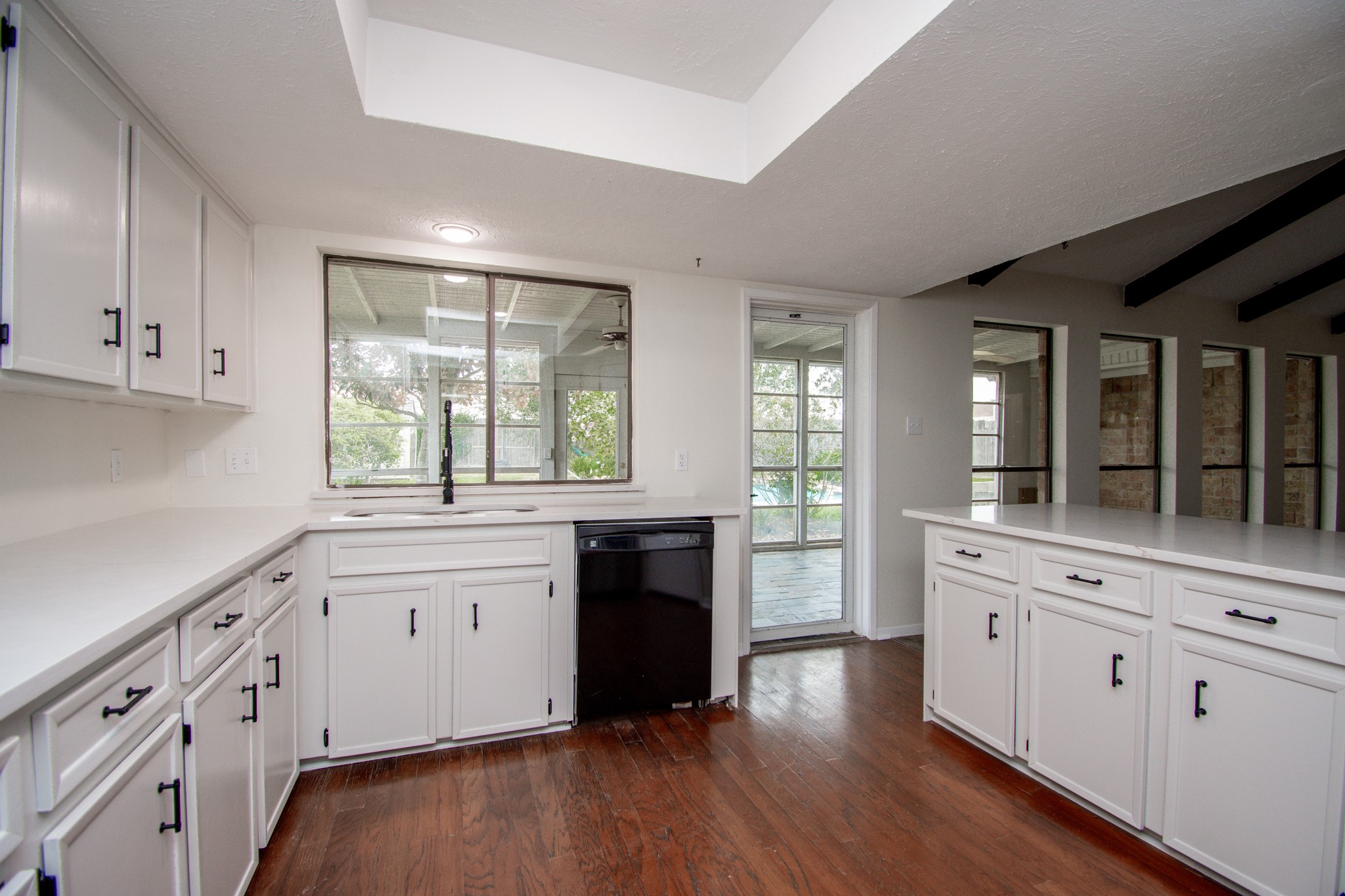 Bright white kitchen with hardwood floors.