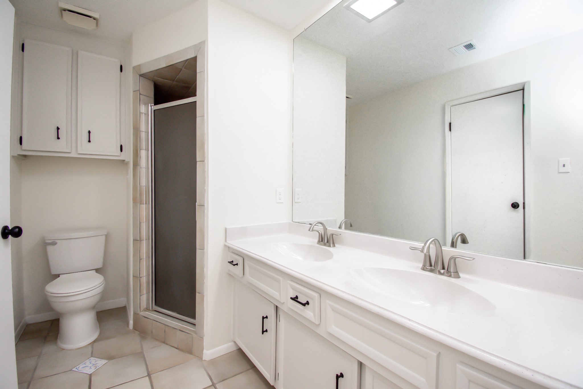 Primary Bath with double sinks, plenty of cabinet storage and a spacious shower