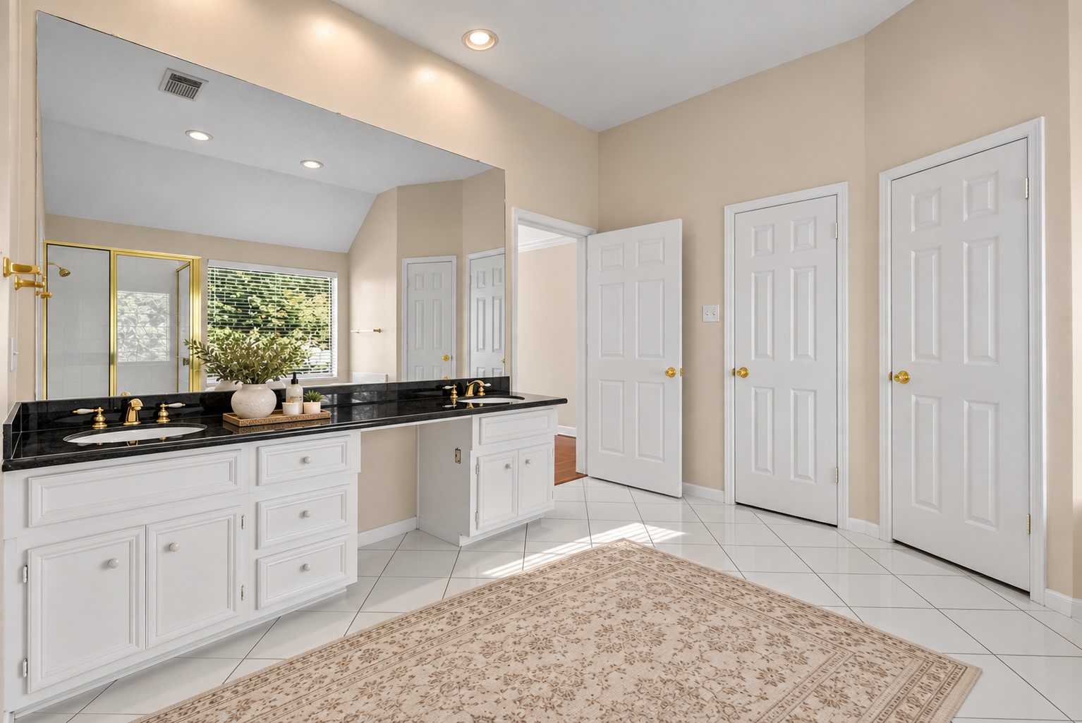 The primary bedroom features a private en-suite featuring dual sinks, soaking tub and separate walk-in shower.