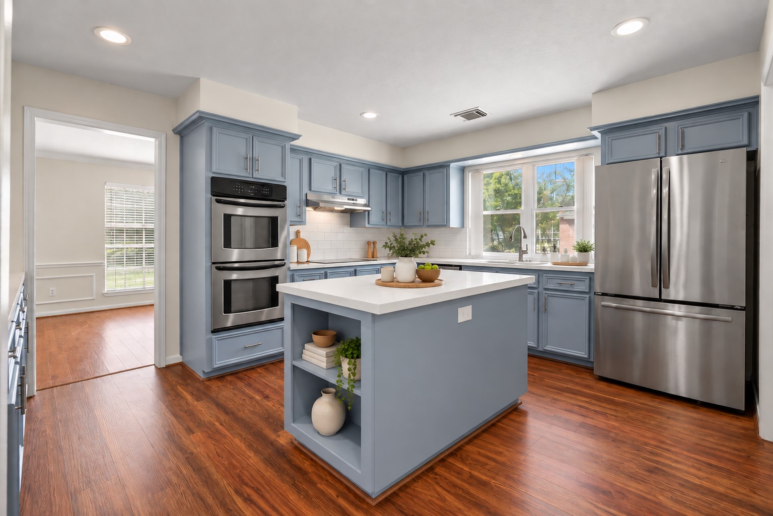 The updated chef-inspired island kitchen showcases extensive countertops, rich solid wood cabinetry, stainless steel appliances and double ovens.
