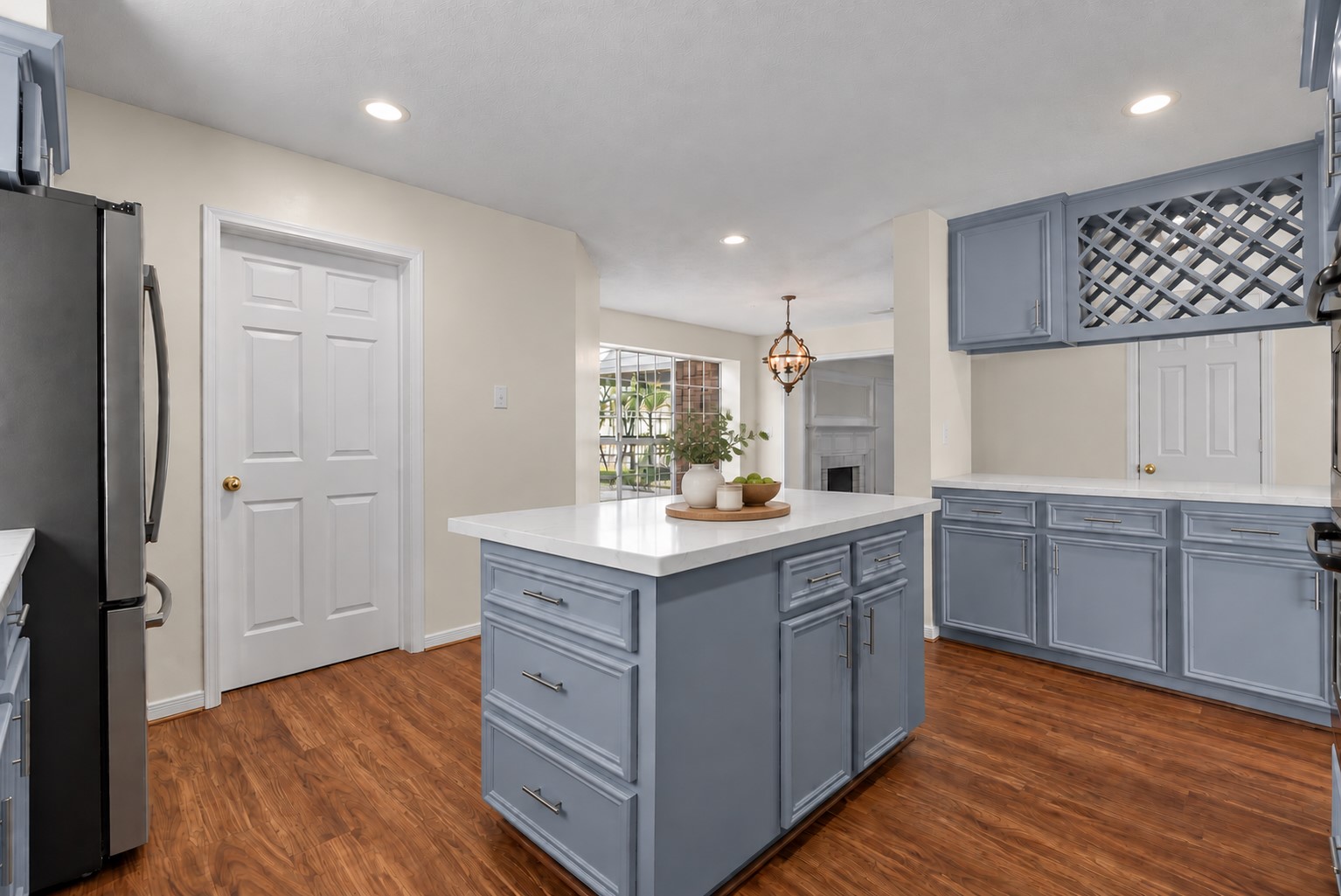 The updated chef-inspired island kitchen showcases extensive countertops, rich solid wood cabinetry, stainless steel appliances and double ovens.