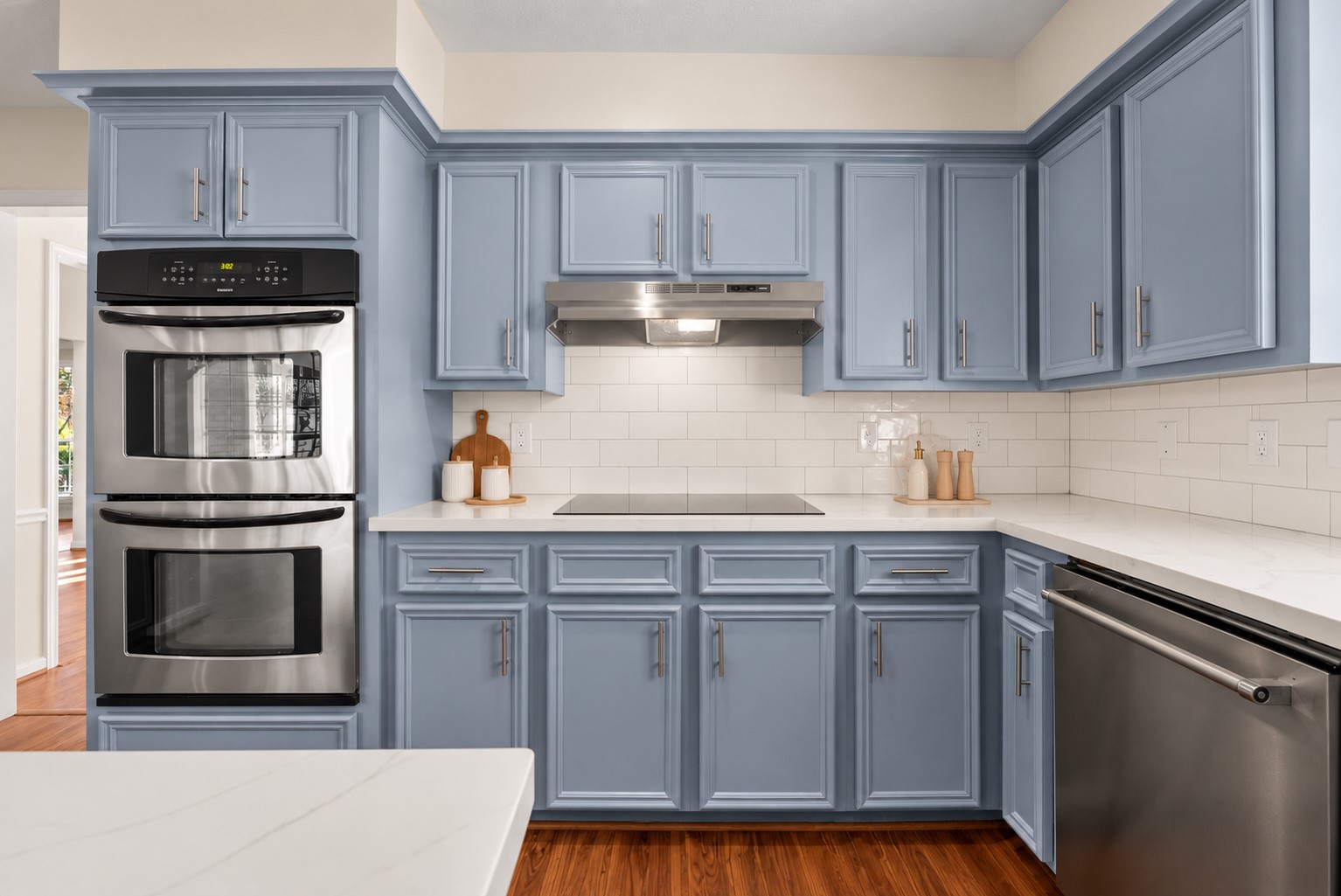 The updated chef-inspired island kitchen showcases extensive countertops, rich solid wood cabinetry, stainless steel appliances and double ovens.