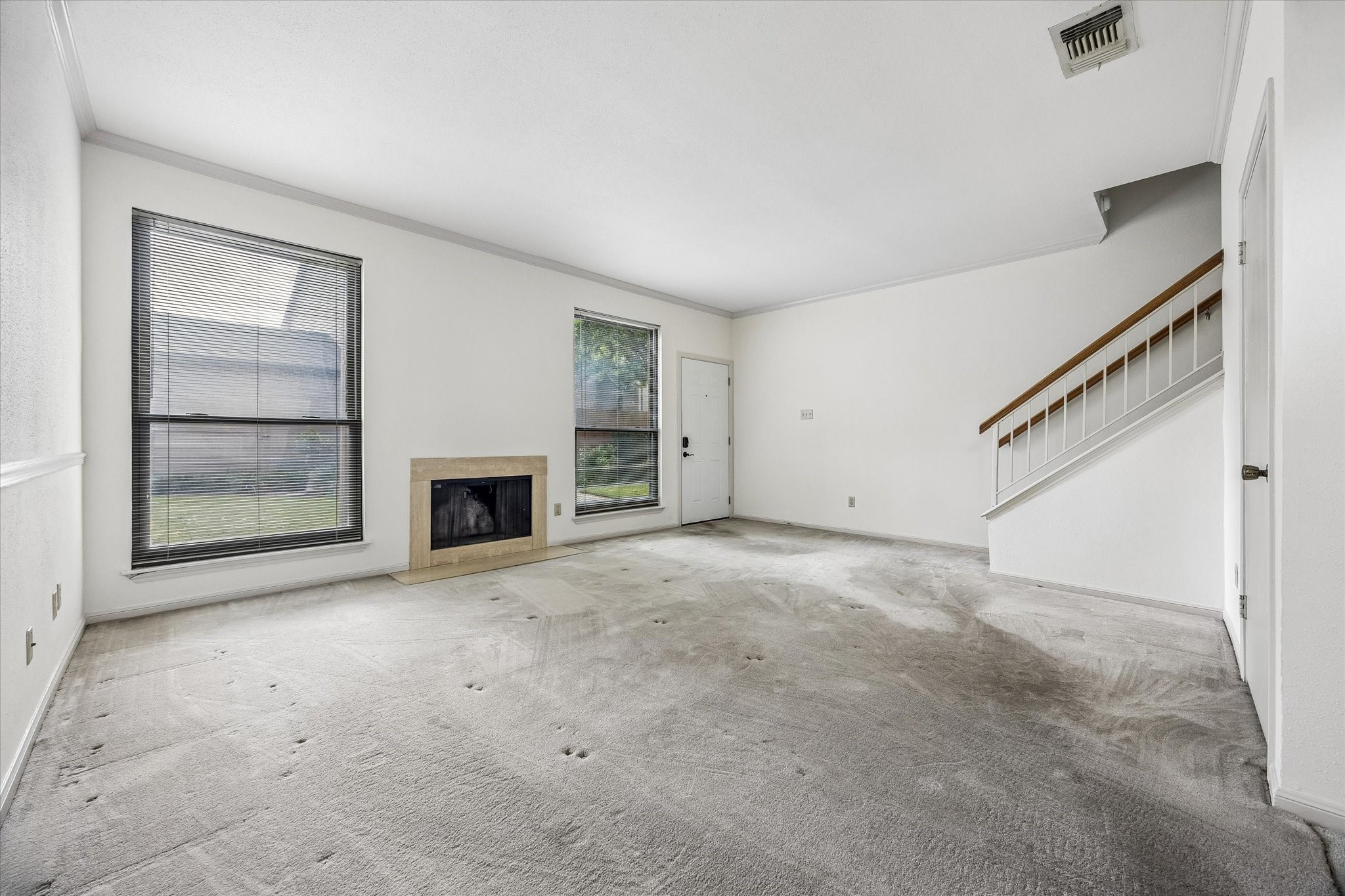 High ceilings with a wood burning fireplace in the living room