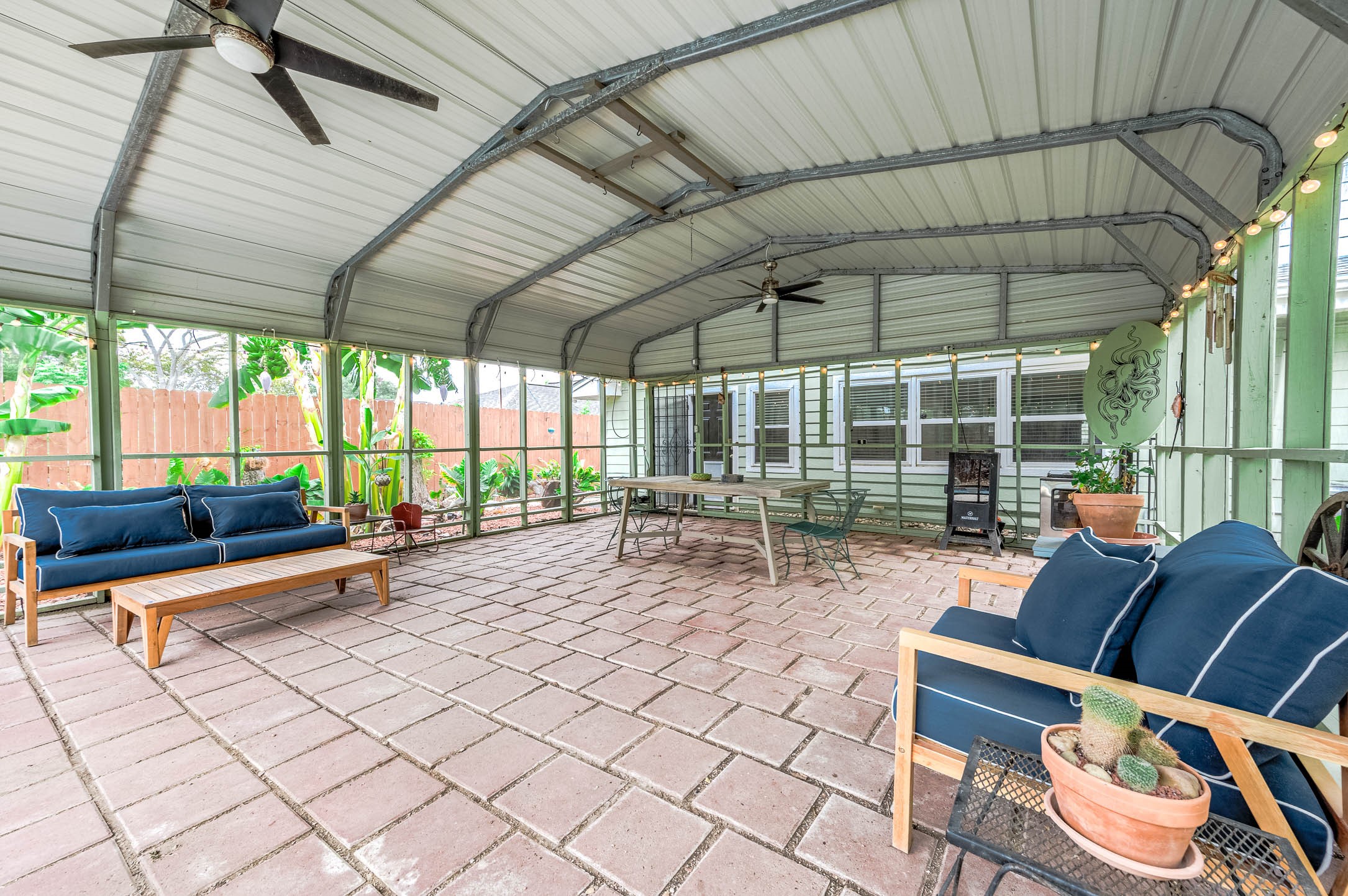 Paver-floored screened porch steps out to the pool.
