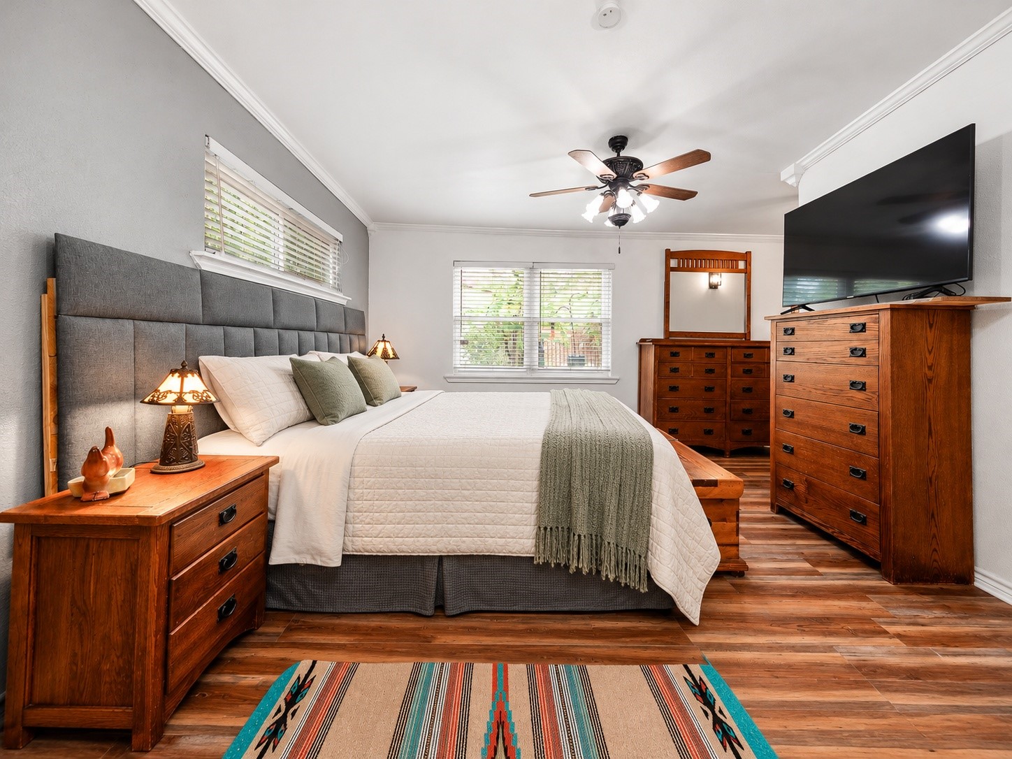 Primary bedroom with ceiling fan and plenty of space for bedroom furniture.