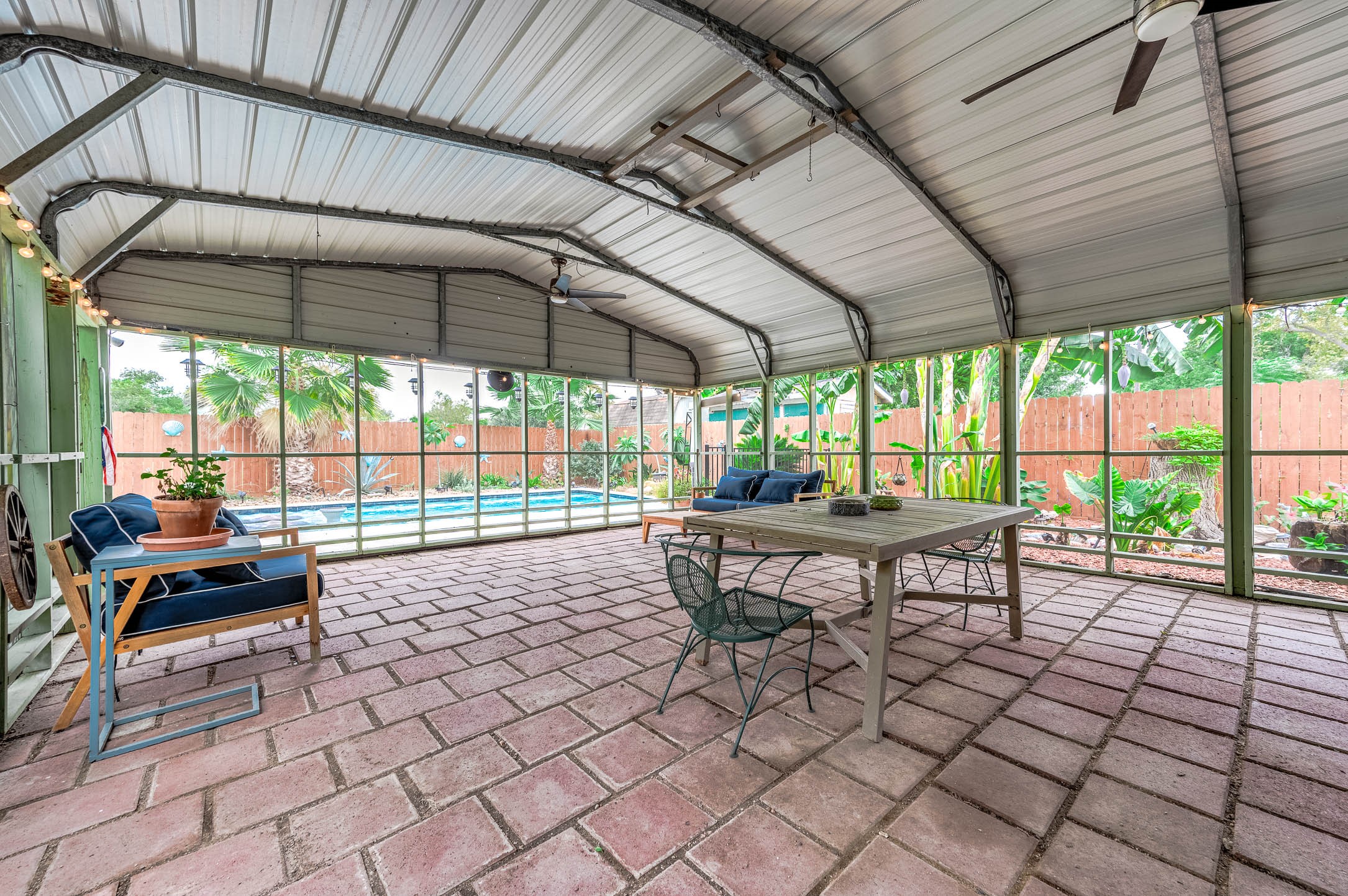 Screened back porch overlooking the pool - perfect for year-round outdoor living.