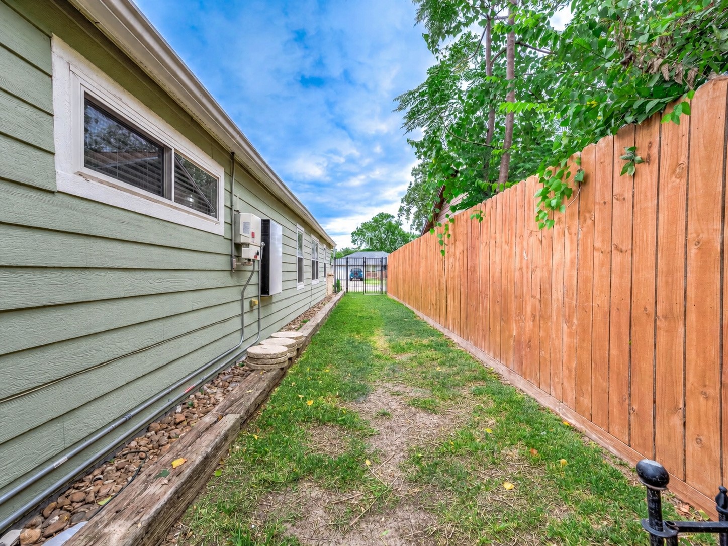 Fenced dog run along the side of the home.