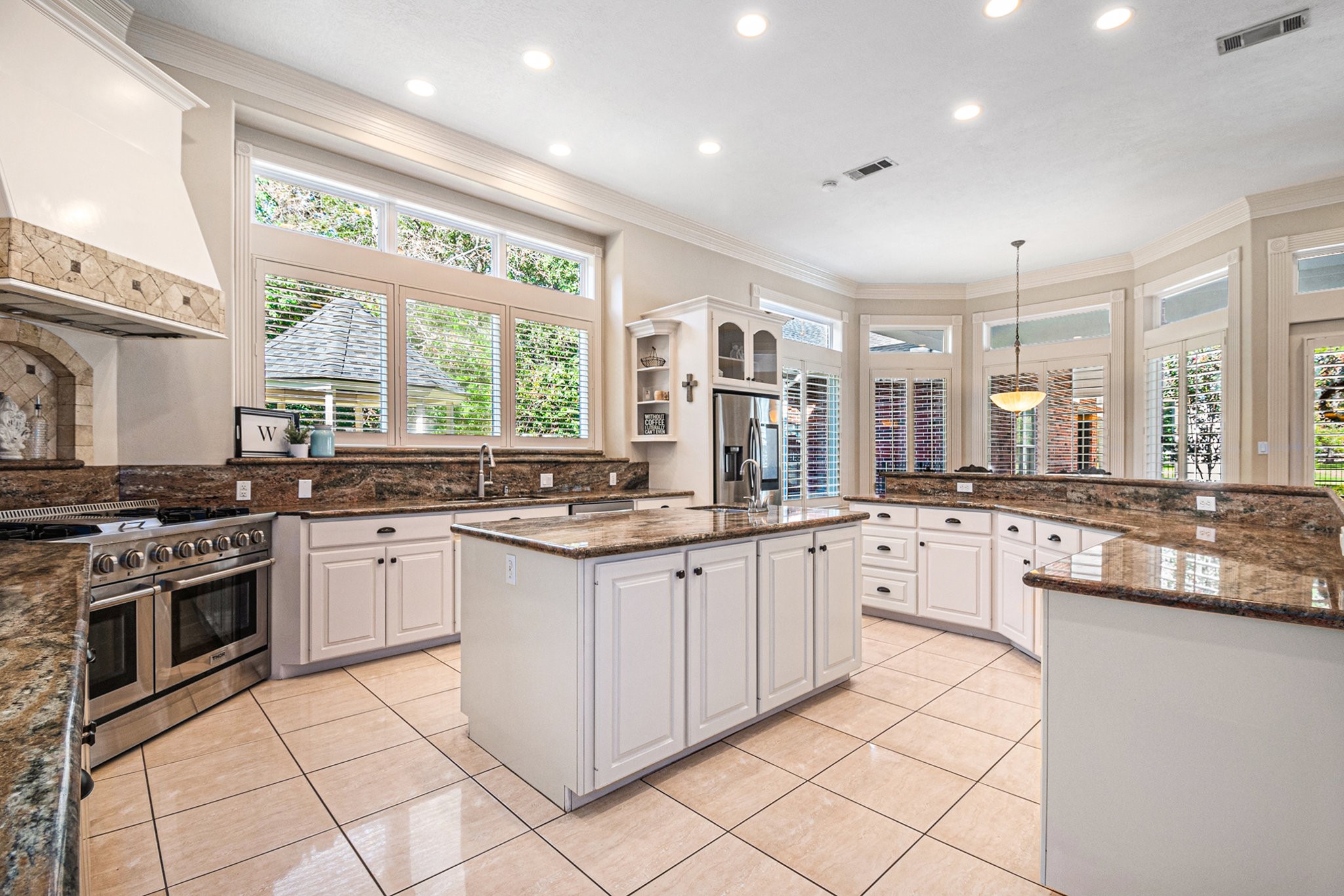 Chef's DREAM kitchen showcases granite countertops, a massive island with an extra sink, and ample breakfast bar seating.