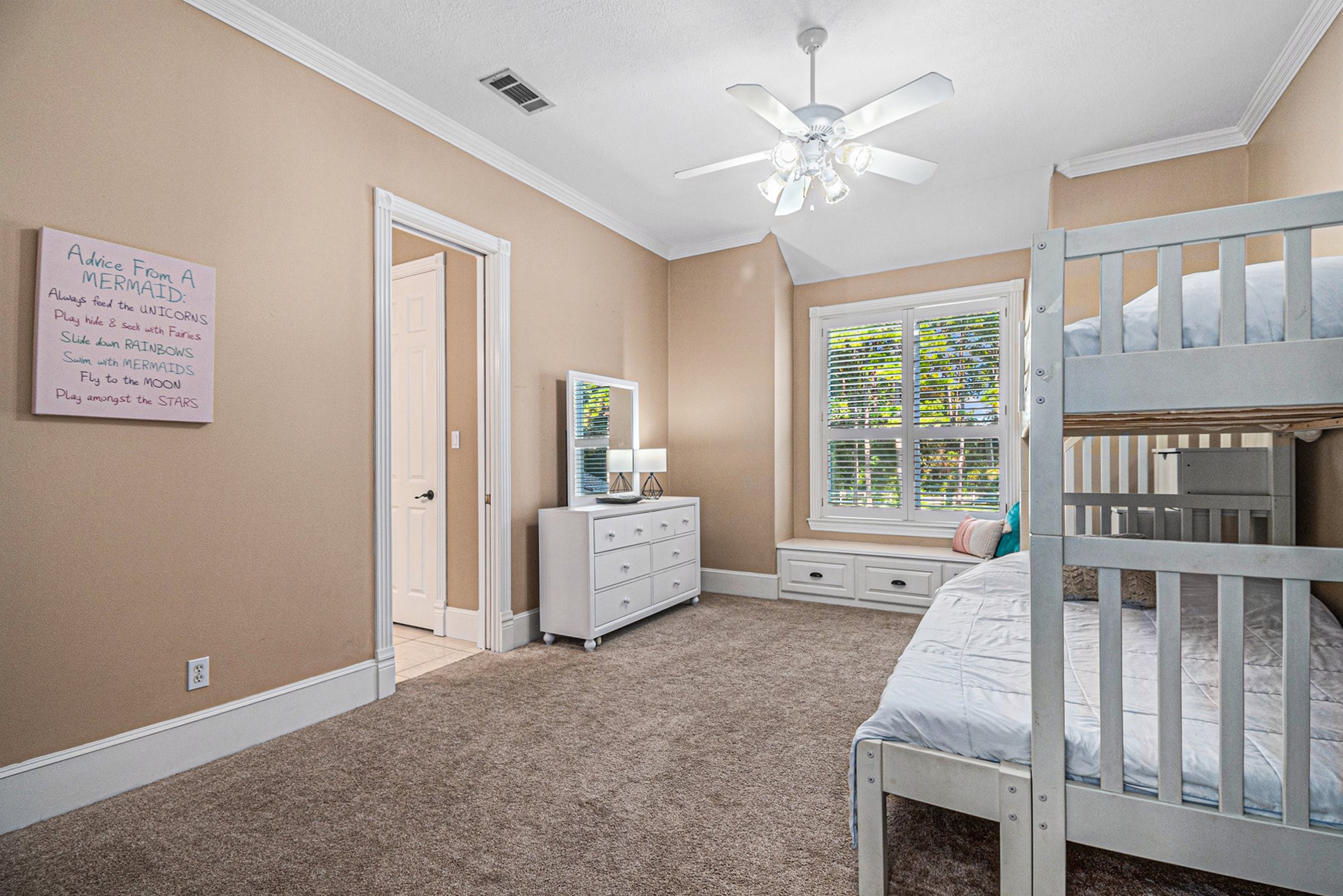 Adorable upstairs secondary bedroom with a reading bench.