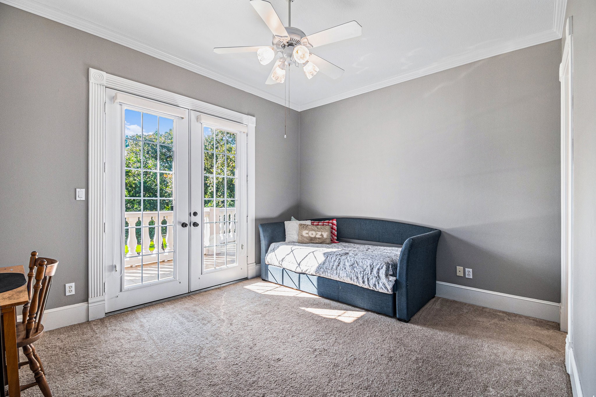 Additional secondary bedroom with a private bathroom and access to the balcony overlooking the front yard.