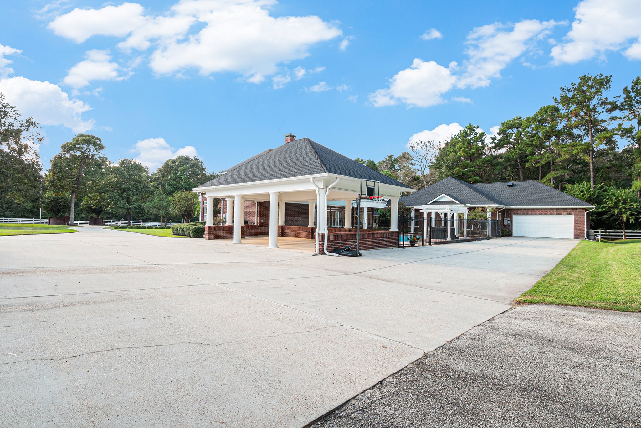 In addition to the 4-car garage, this remarkable property has a 3 car carport and a another 2 car garage off the guest house.