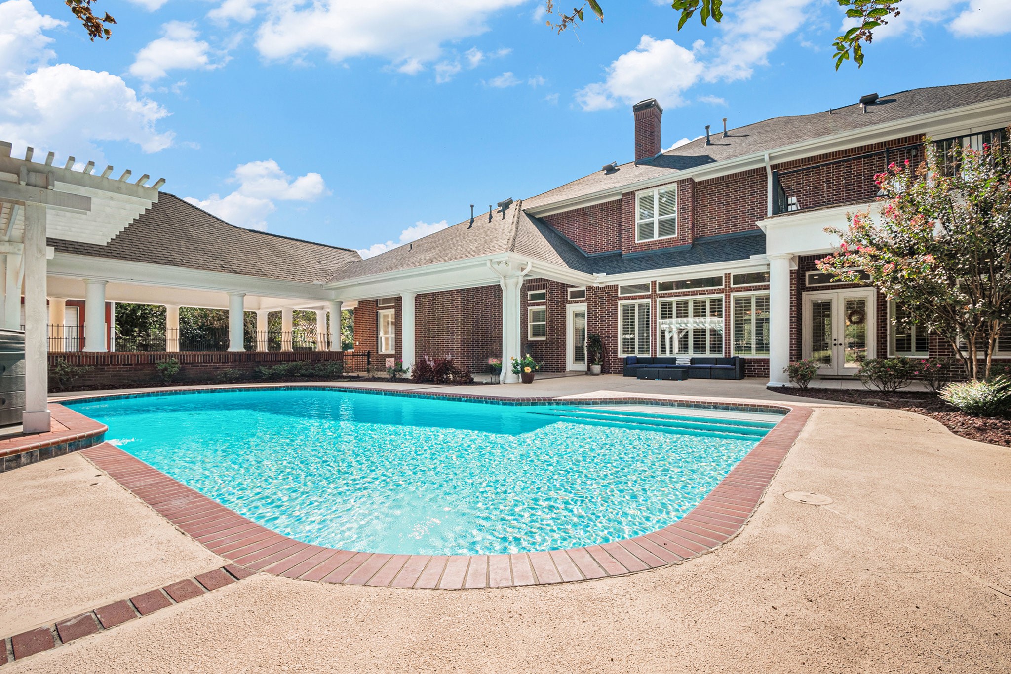 Remarkable backyard oasis showcases a sparkling pool, a hot tub, and tons of space to entertain!