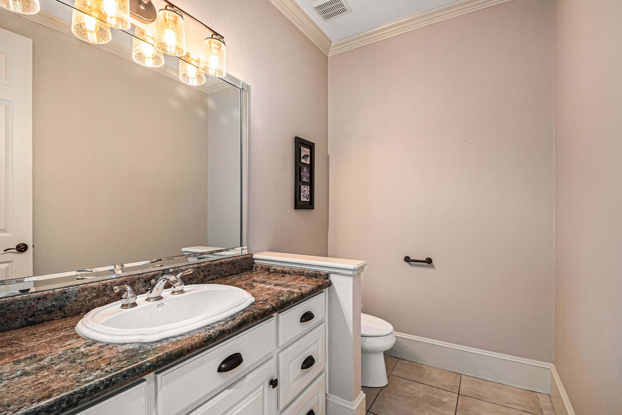 Wonderful half bath with stunning granite countertops.