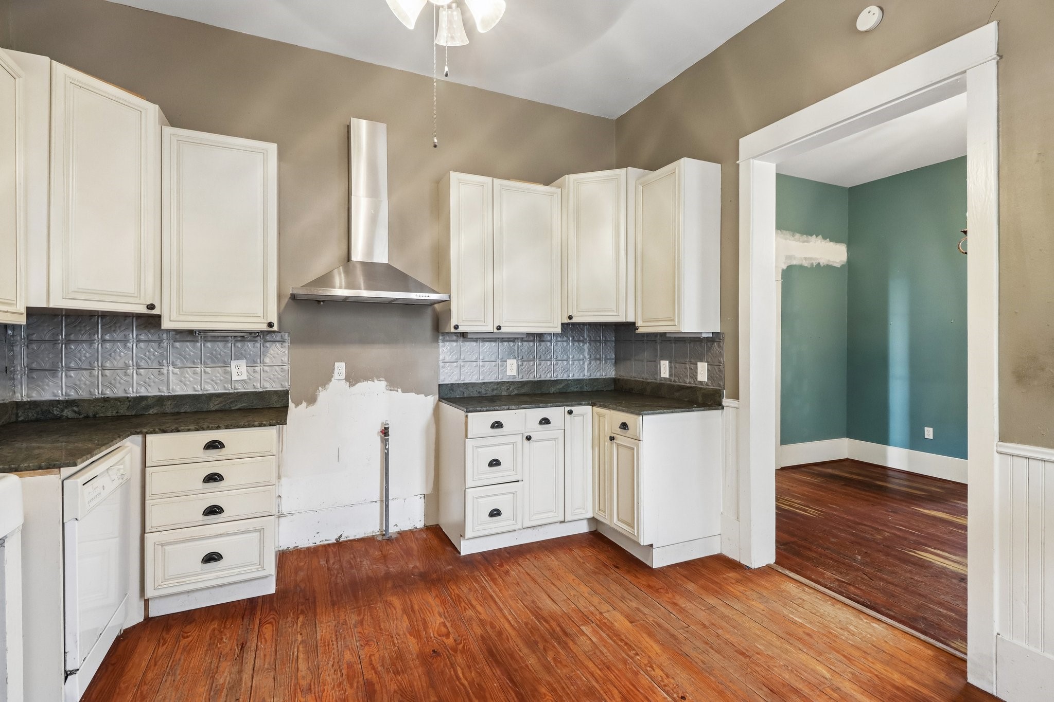 Another view of the kitchens cabinet storage, counter space and window-lined layout.