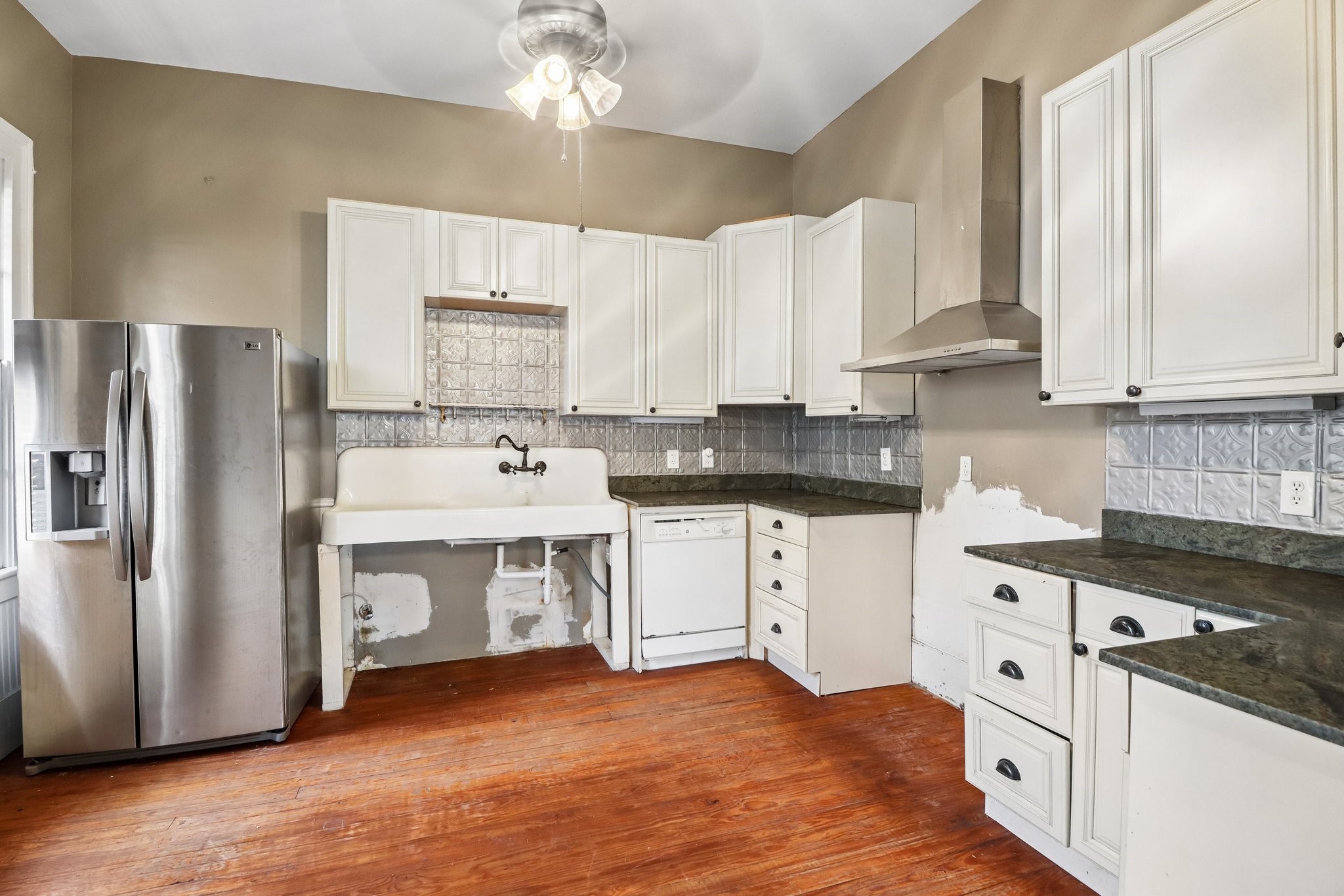 The kitchen pairs white cabinetry with dark countertops and windows that bring in natural light.